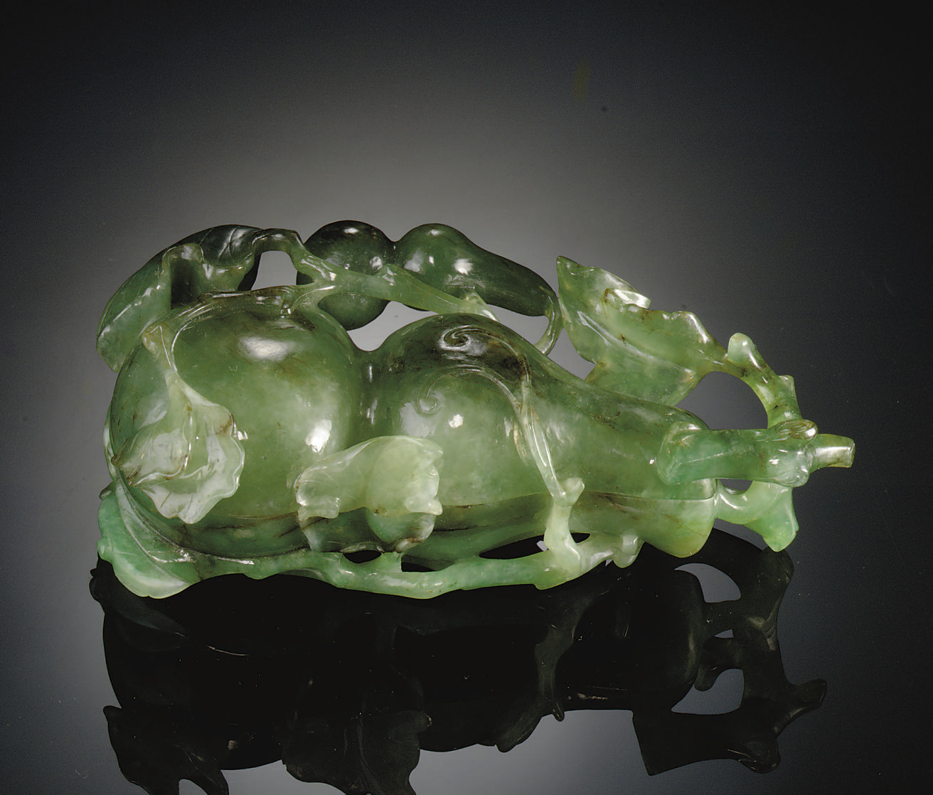 A PAIR OF SMALL GREEN JADEITE CYLINDRICAL CONTAINERS AND COVERS