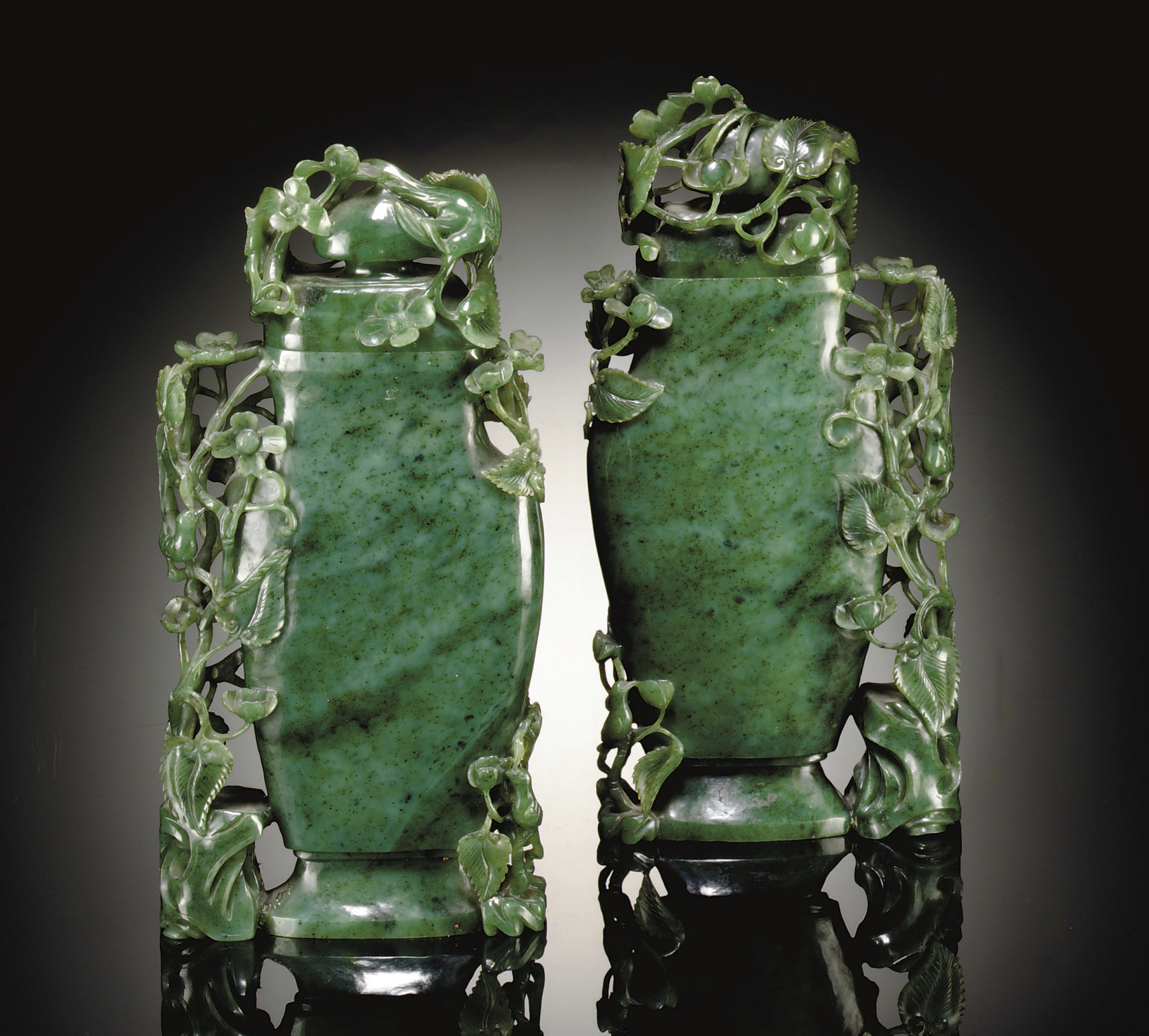 A PAIR OF SMALL GREEN JADEITE CYLINDRICAL CONTAINERS AND COVERS