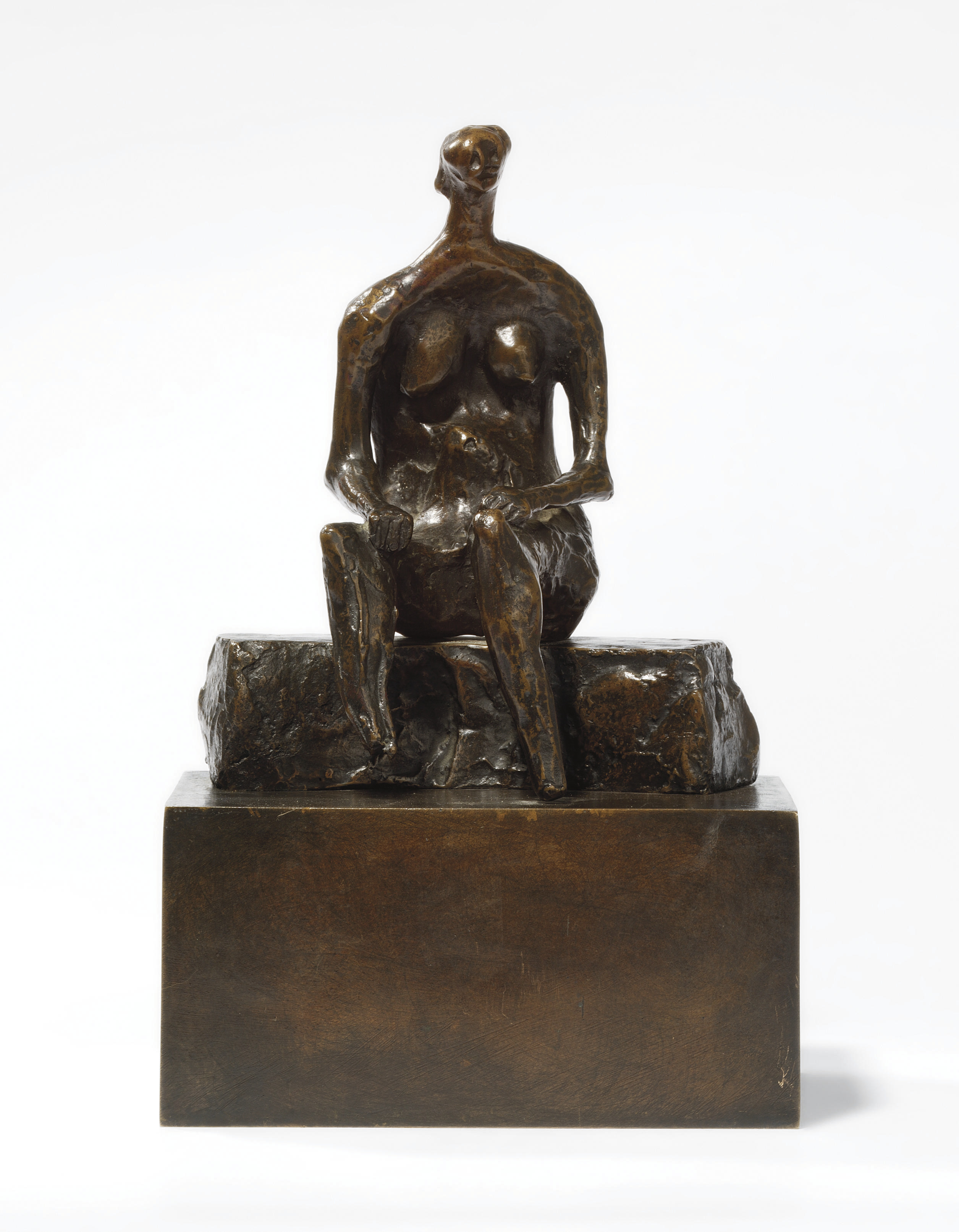 Seated woman on curved block 
