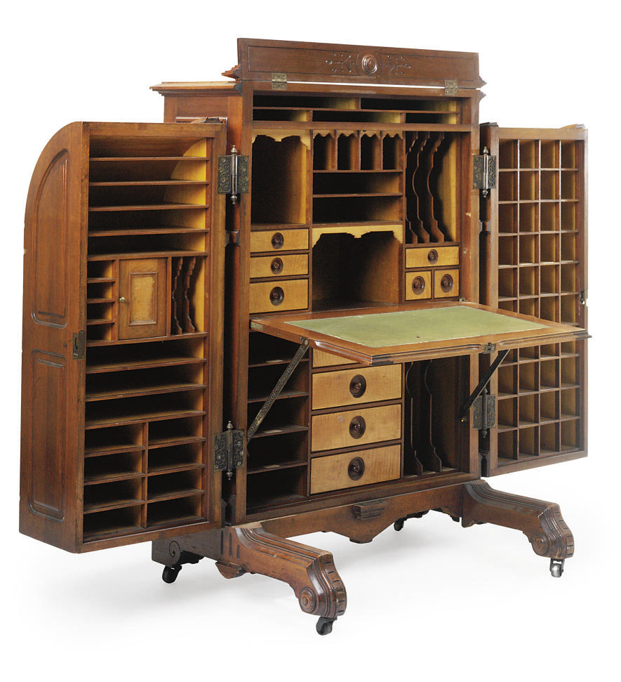 AN AMERICAN WALNUT AND BURRWALNUT POST OFFICE DESK , BY THE WOOTON