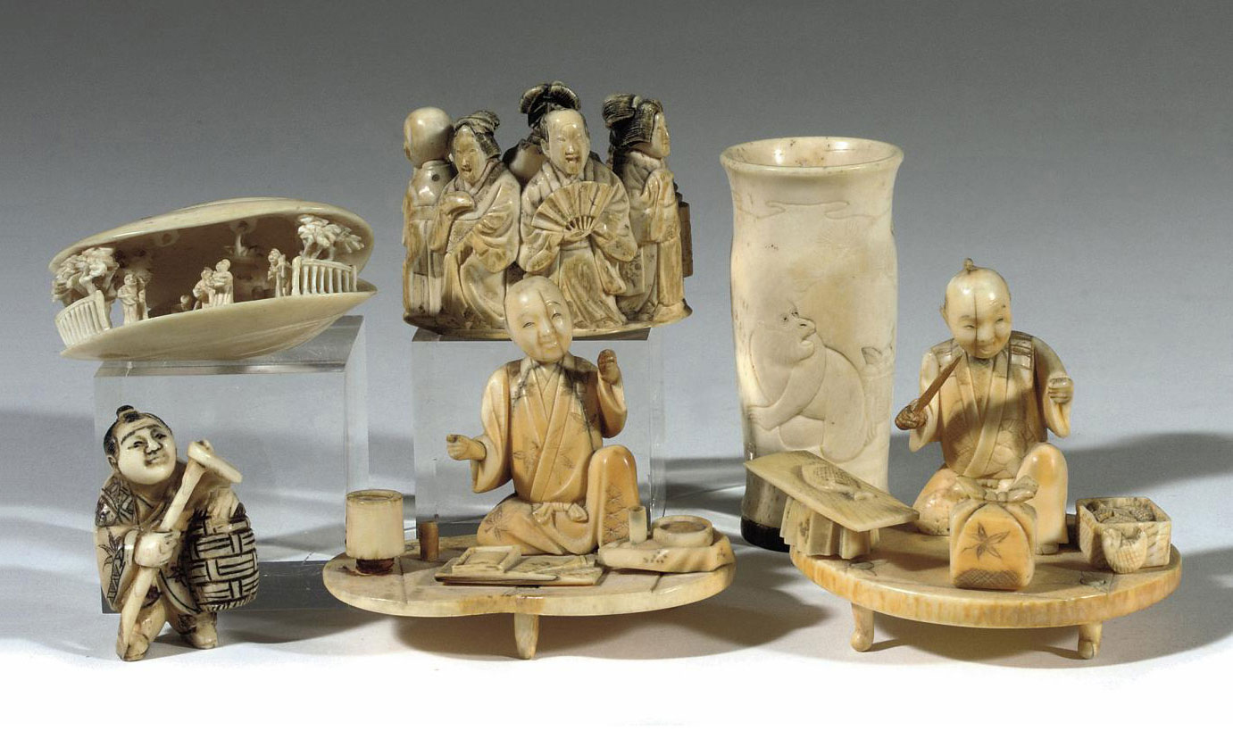 Four various Japanese ivory carvings, a small vase and a netsuke