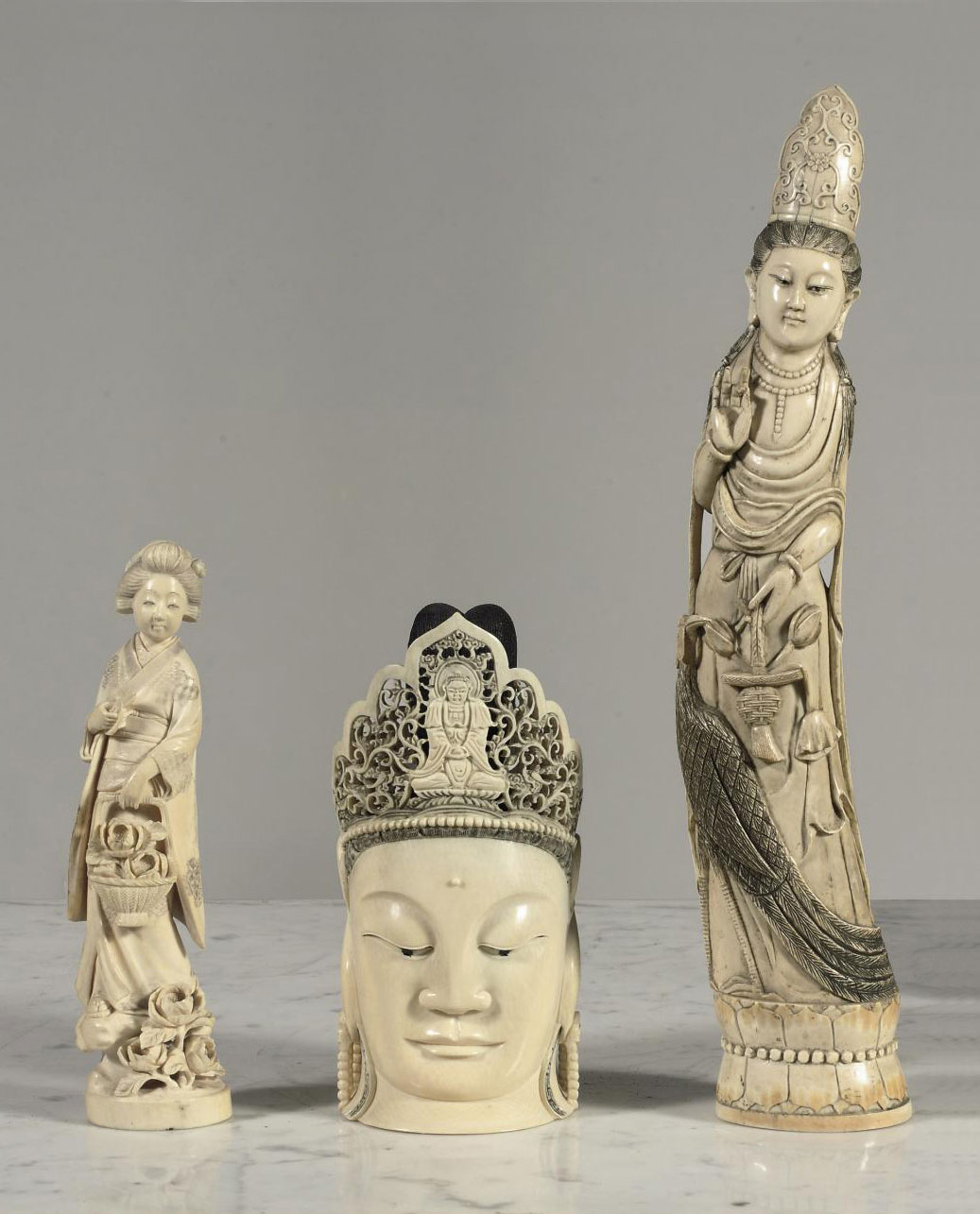A CHINESE IVORY CARVING OF A GUANYIN HEAD, A FIGURE OF A LADY AND A