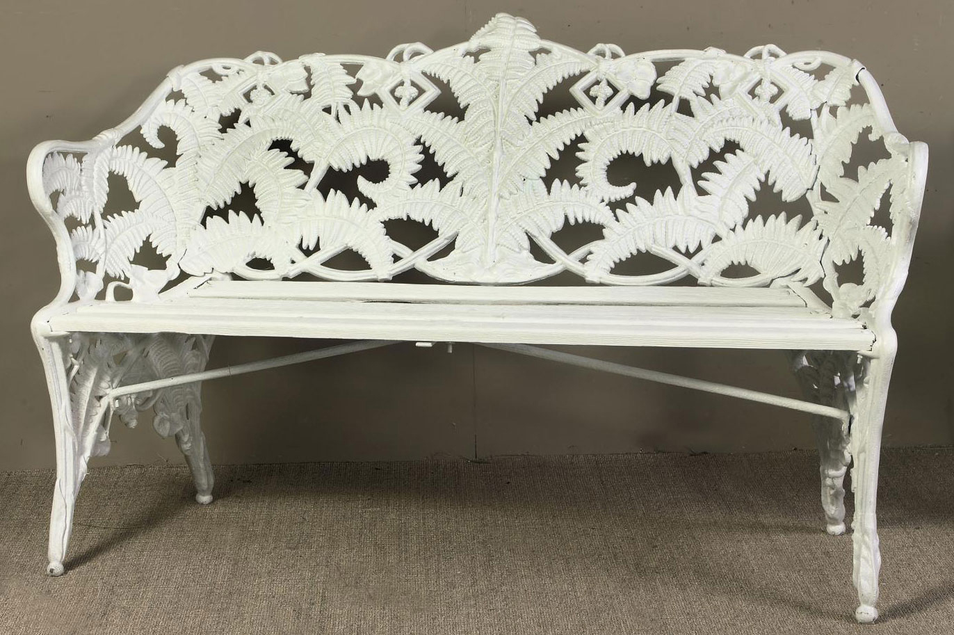 A SWEDISH WHITE-PAINTED CAST-IRON GARDEN BENCH , BY J.C.G. BOLINDER