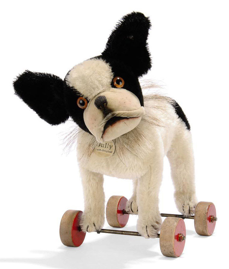 A STEIFF BULLY ON WHEELS, (1317ex), black and white mohair, brown