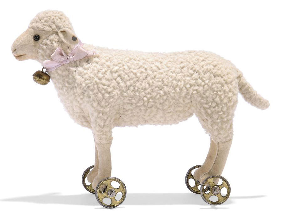 A STEIFF WOOL PLUSH LAMB ON WHEELS, (1517), white, black boot