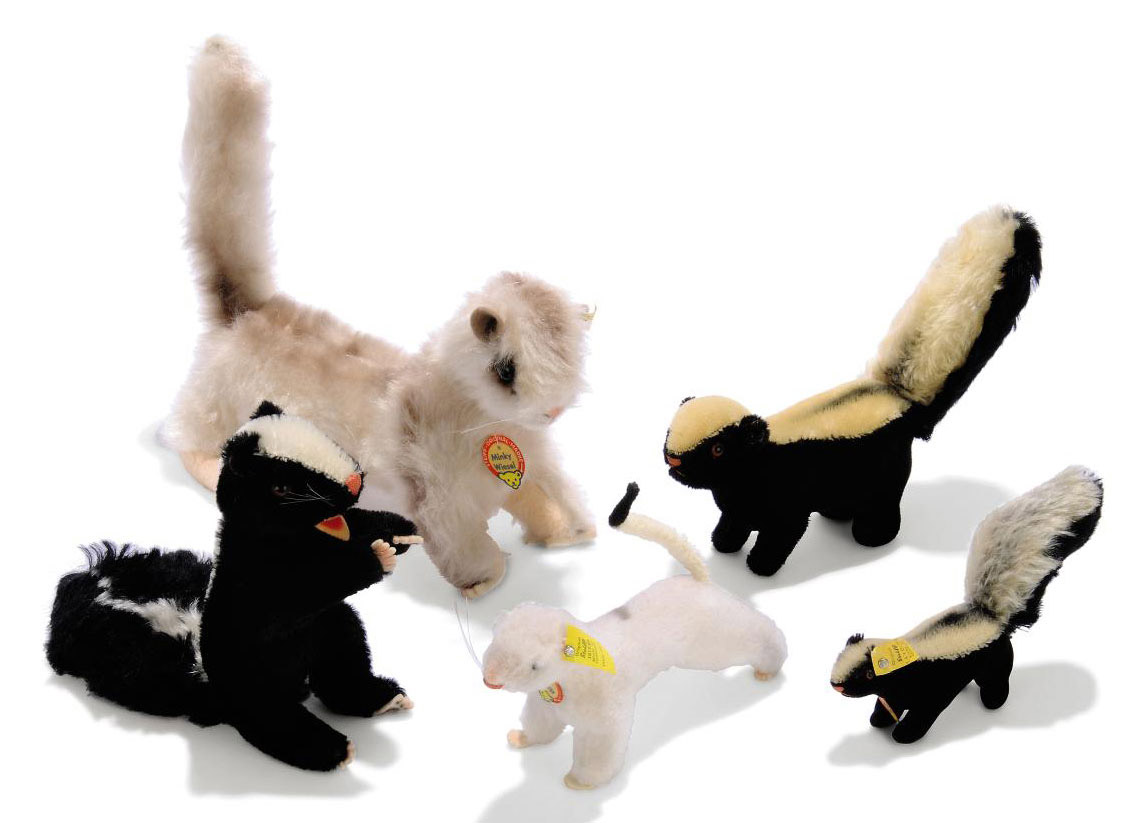 A STEIFF SPECIAL ORDER PHUY SKUNK begging black and white mohair brown and black glass eyes pink stitching open felt mouth whiskers and felt claws 1965 7 in. 18.5cm. high a Minky Weasel