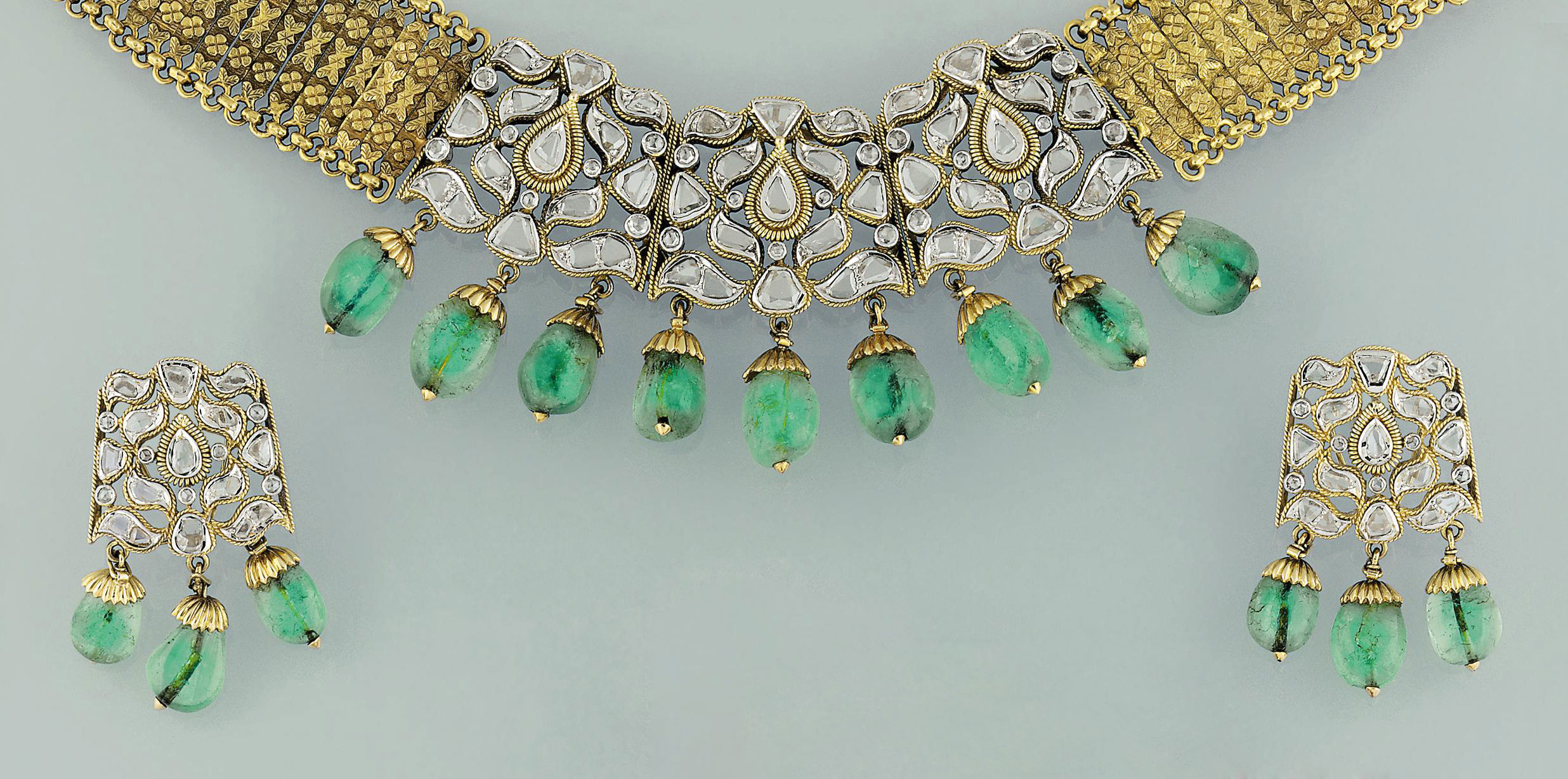 An Indian Diamond And Emerald Necklace And Earrings 18k gold detachable diamond emerald necklace which can be worn in 6 different ways by kalasha fine jewels. an indian diamond and emerald necklace
