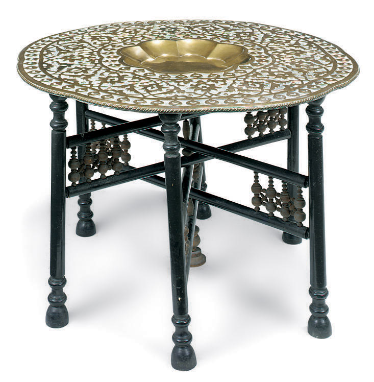 AN INDIAN BRASS DISHED TRAY ON EBONISED STAND , JAIPUR, EARLY 20TH