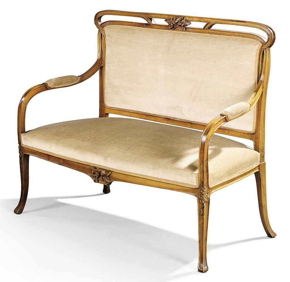 AN ART NOUVEAU WALNUT AND VELVET UPHOLSTERED SOFA IN THE STYLE OF