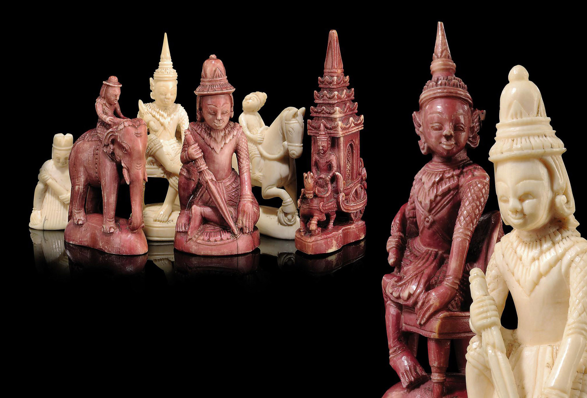 A SOUTH EAST ASIAN CARVED IVORY FIGURAL CHESS SET , PROBABLY BURMESE