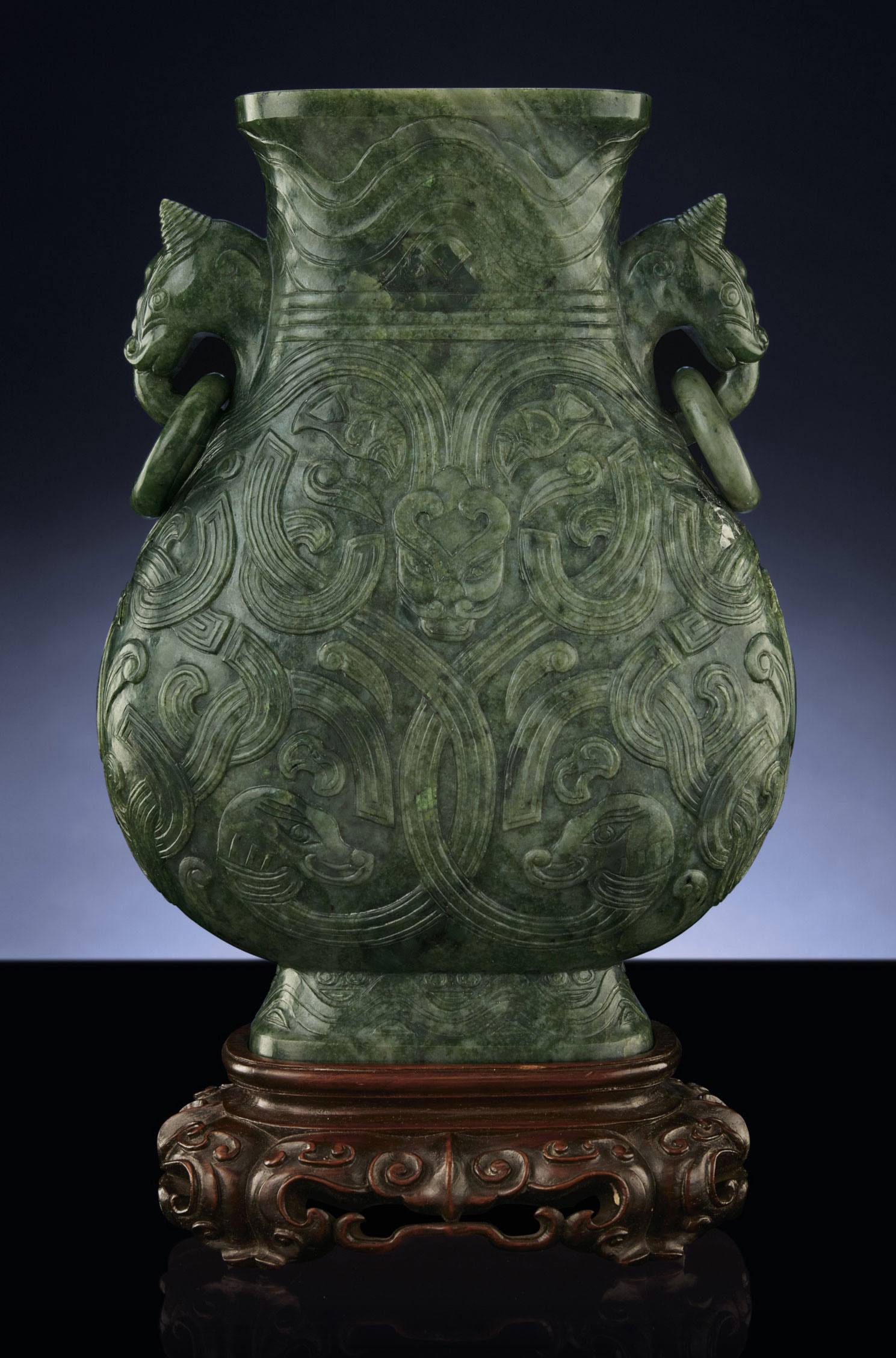 A FINELY CARVED SPINACHGREEN JADE VASE, HU , QING DYNASTY, 18TH