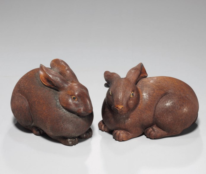 A pair of carved wood rabbits