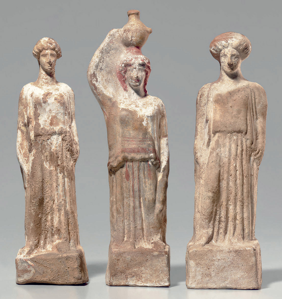 THREE GREEK TERRACOTTA FEMALE FIGURES , CLASSICAL PERIOD, CIRCA MID 5TH