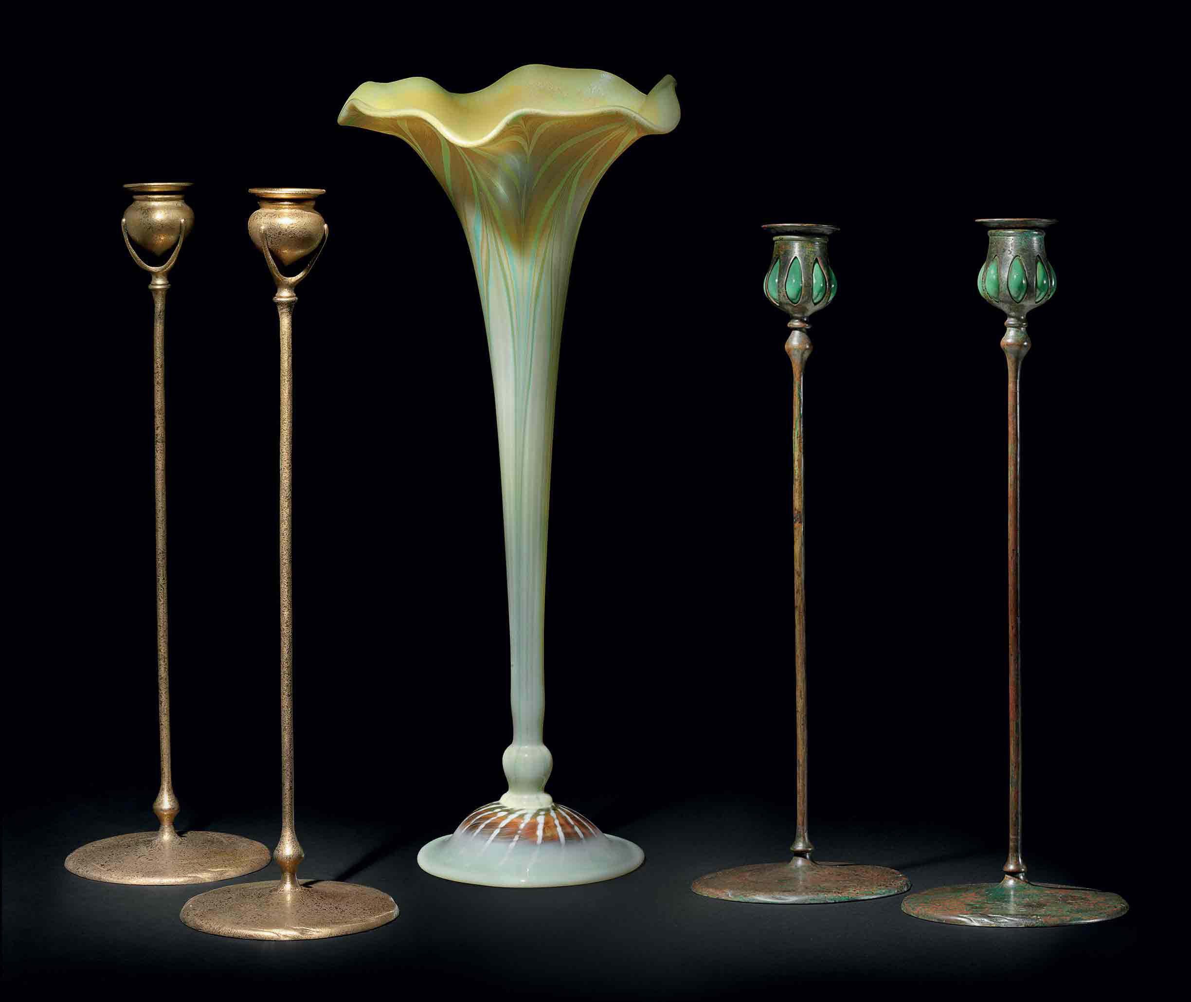 TIFFANY STUDIOS , A PAIR OF FAVRILE GLASS AND BRONZE CANDLESTICKS, CIRCA 1910 Christie's