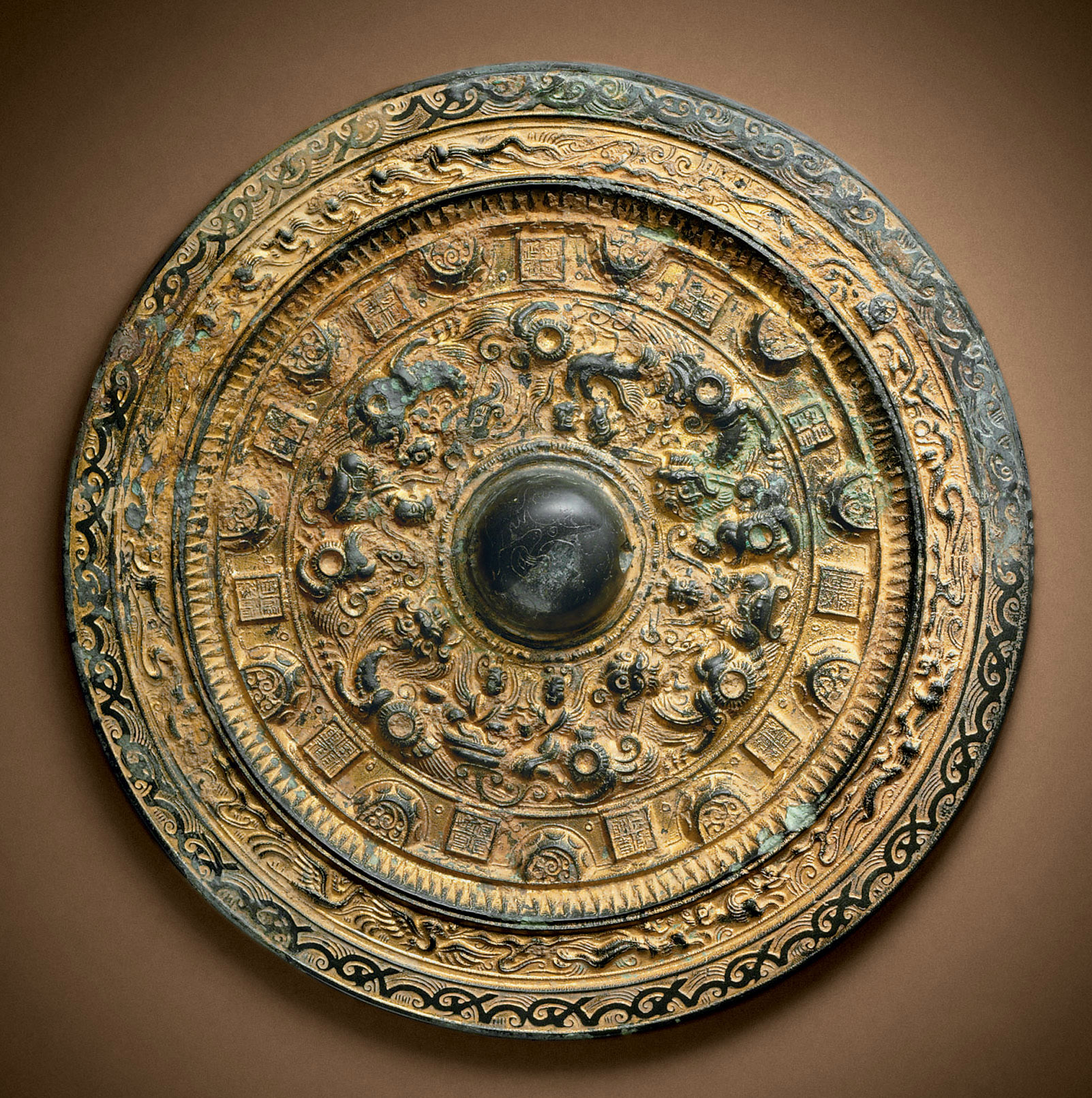 A RARE GILDED BRONZE MIRROR , LATE EASTERN HAN/THREE KINGDOMS PERIOD, LATE 2ND/3RD CENTURY