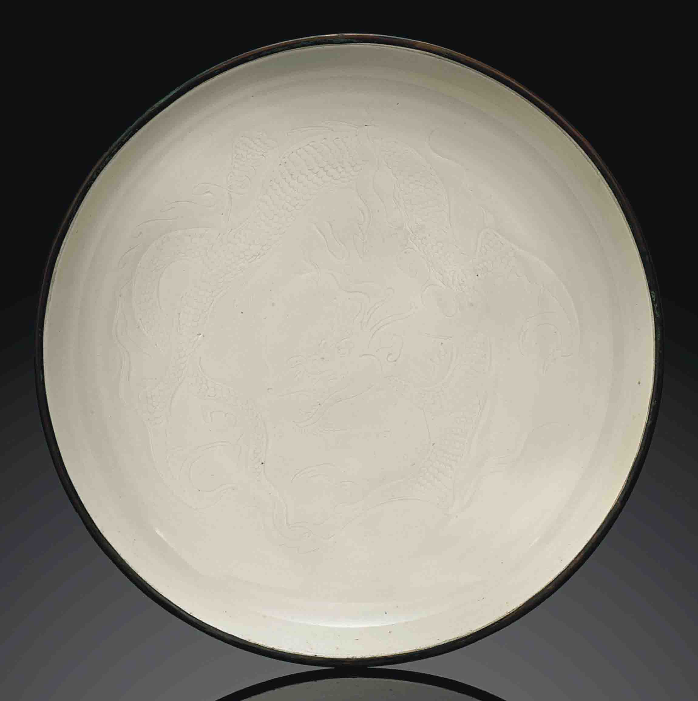 AN IMPORTANT LARGE DINGYAO CARVED 'DRAGON' DISH , NORTHERN SONG