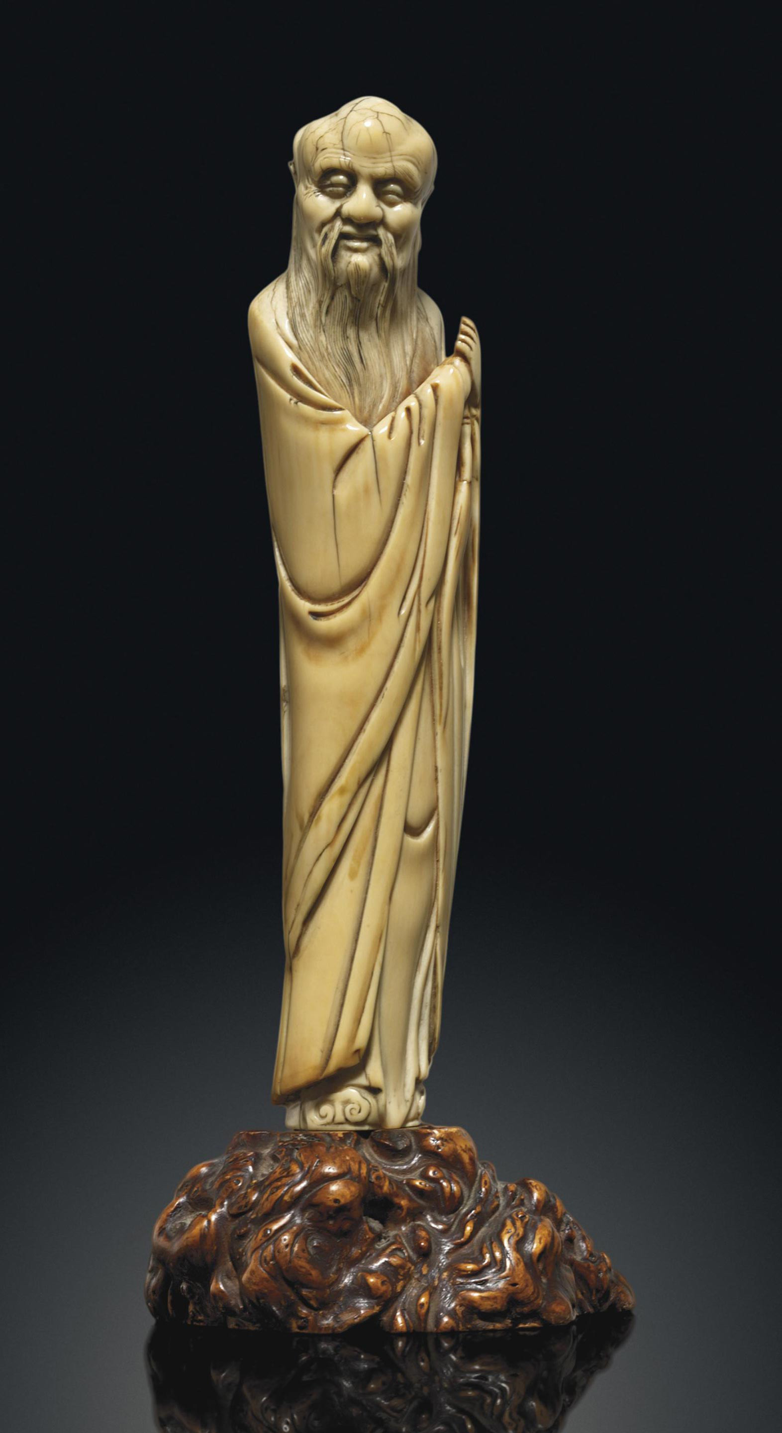 AN IVORY CARVING OF A SCHOLAR , LATE MING DYNASTY, 17TH CENTURY