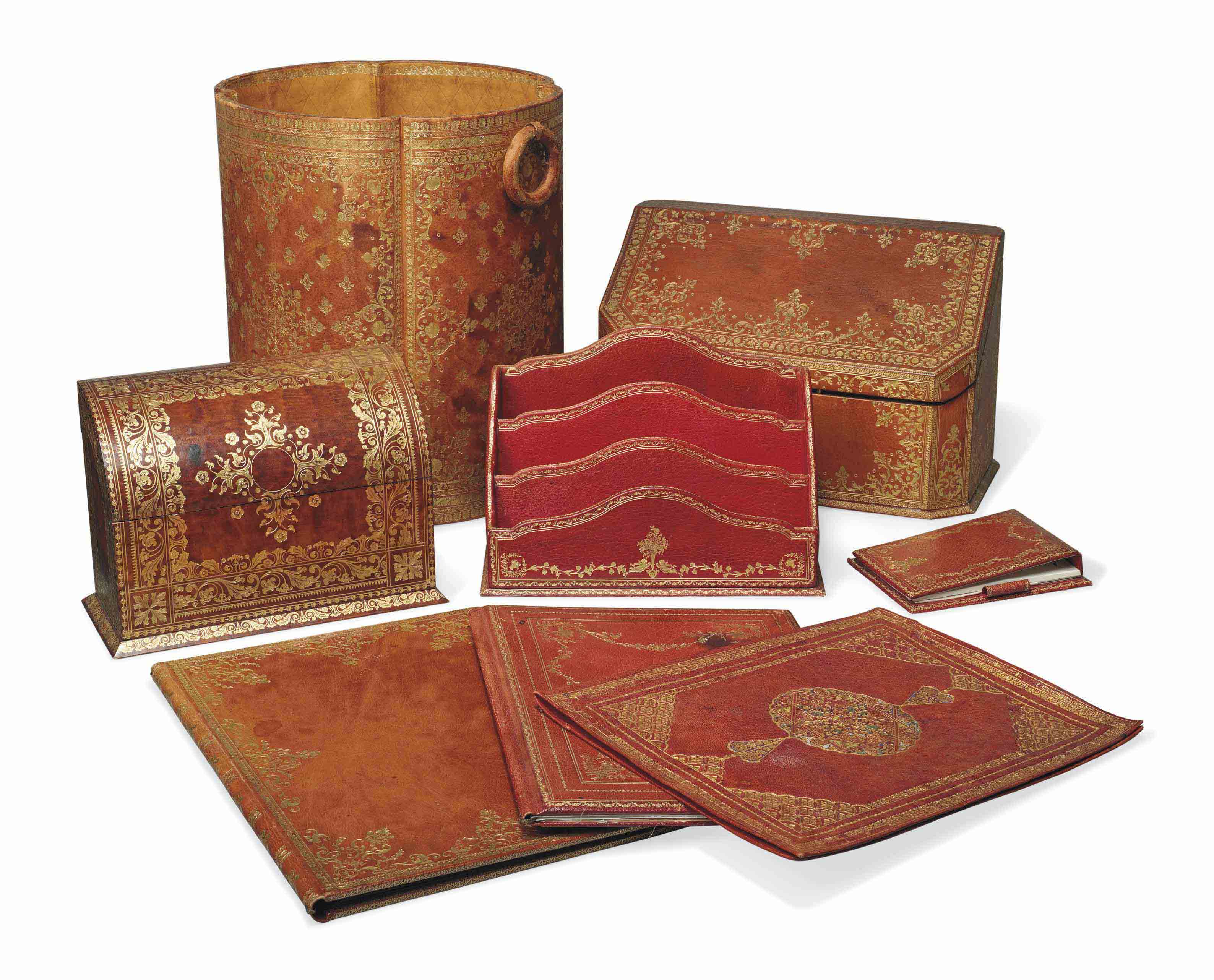 A MATCHED SET OF BROWN AND RED LEATHER DESK ACCESSORIES , EARLY 20TH