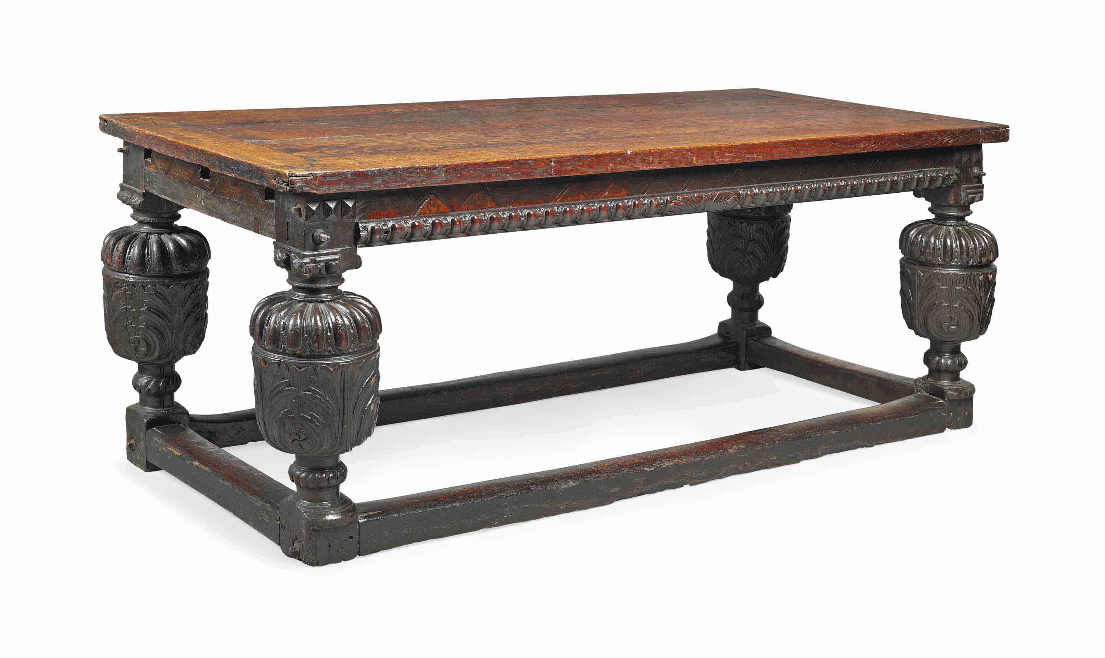 AN ELIZABETHAN CARVED OAK DININGTABLE
