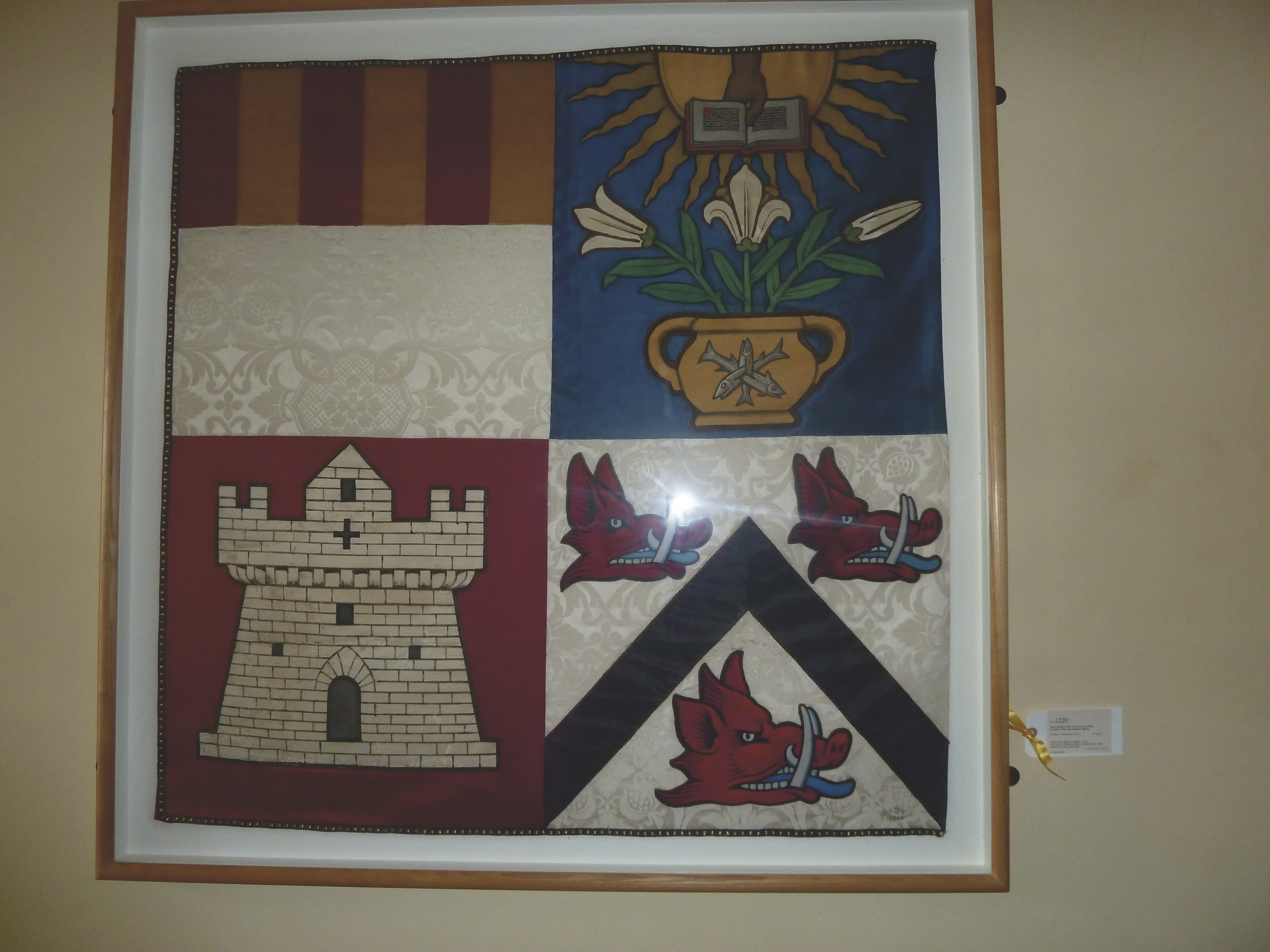A SET OF THREE FABRIC AND APPLIQUEWORK PANELS DEPICTING THE ARMS OF