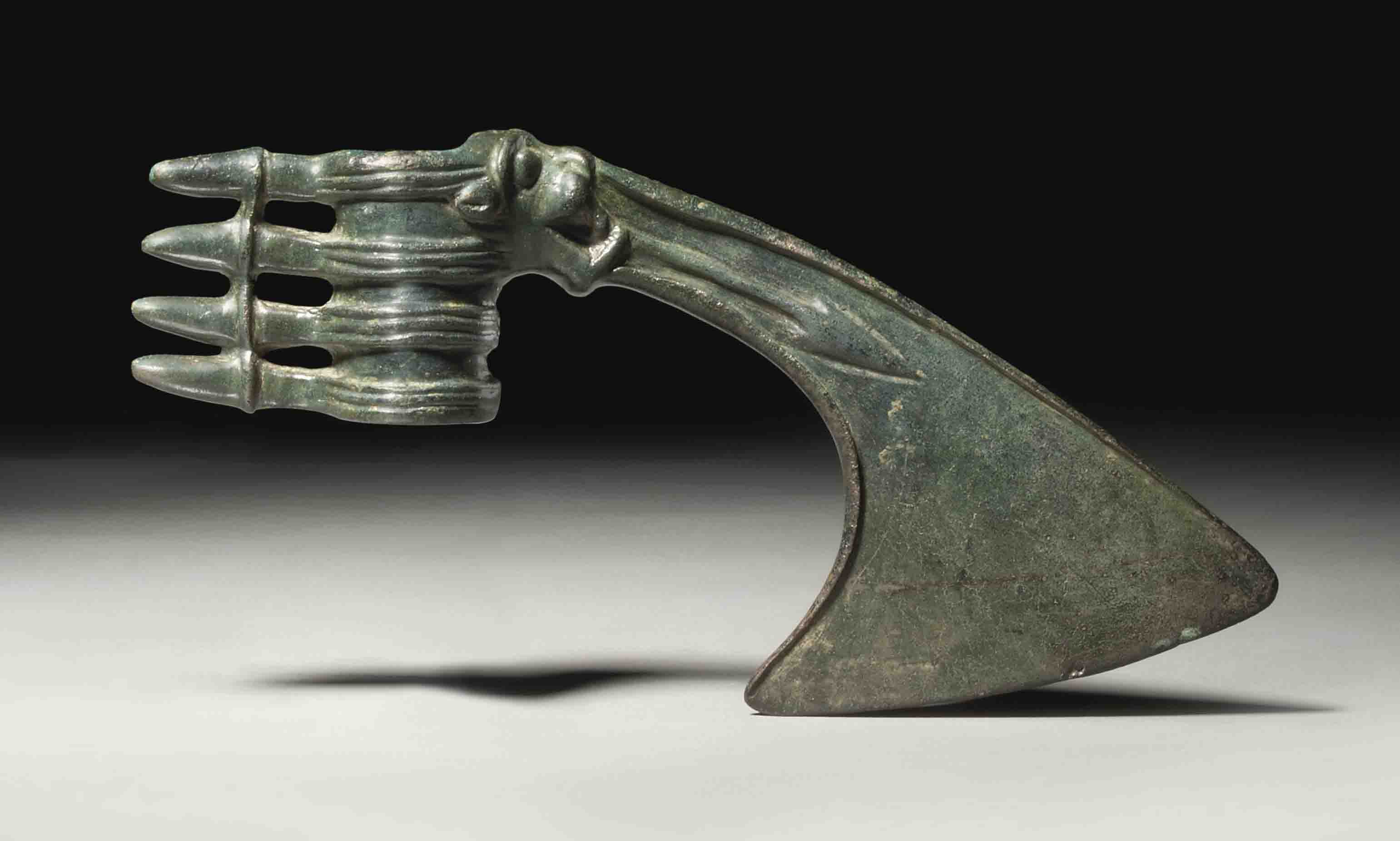 A LURISTAN BRONZE AXE HEAD , CIRCA LATE 2NDEARLY 1ST MILLENNIUM B.C