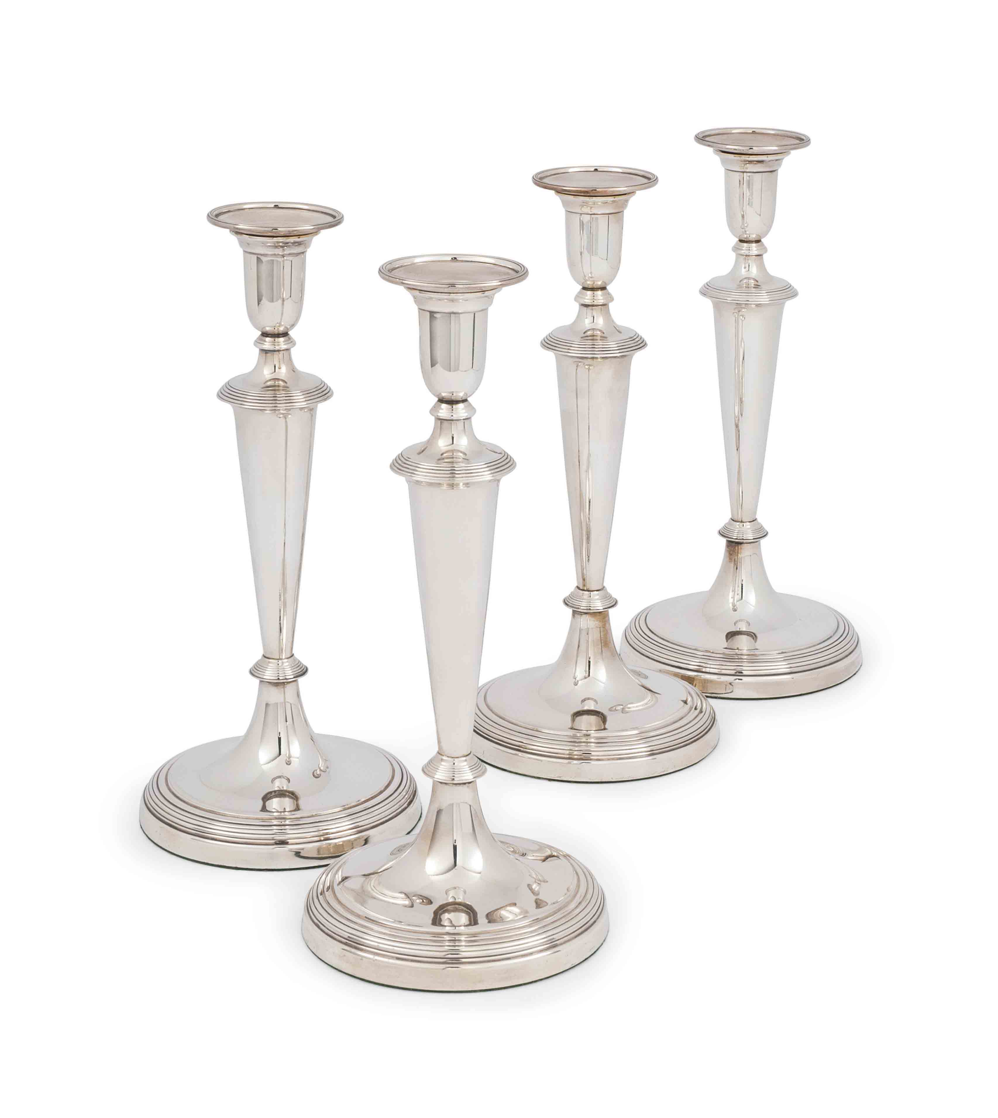 A SET OF FOUR EDWARDIAN SILVER CANDLESTICKS , MARK OF CHARLES CLEMENT