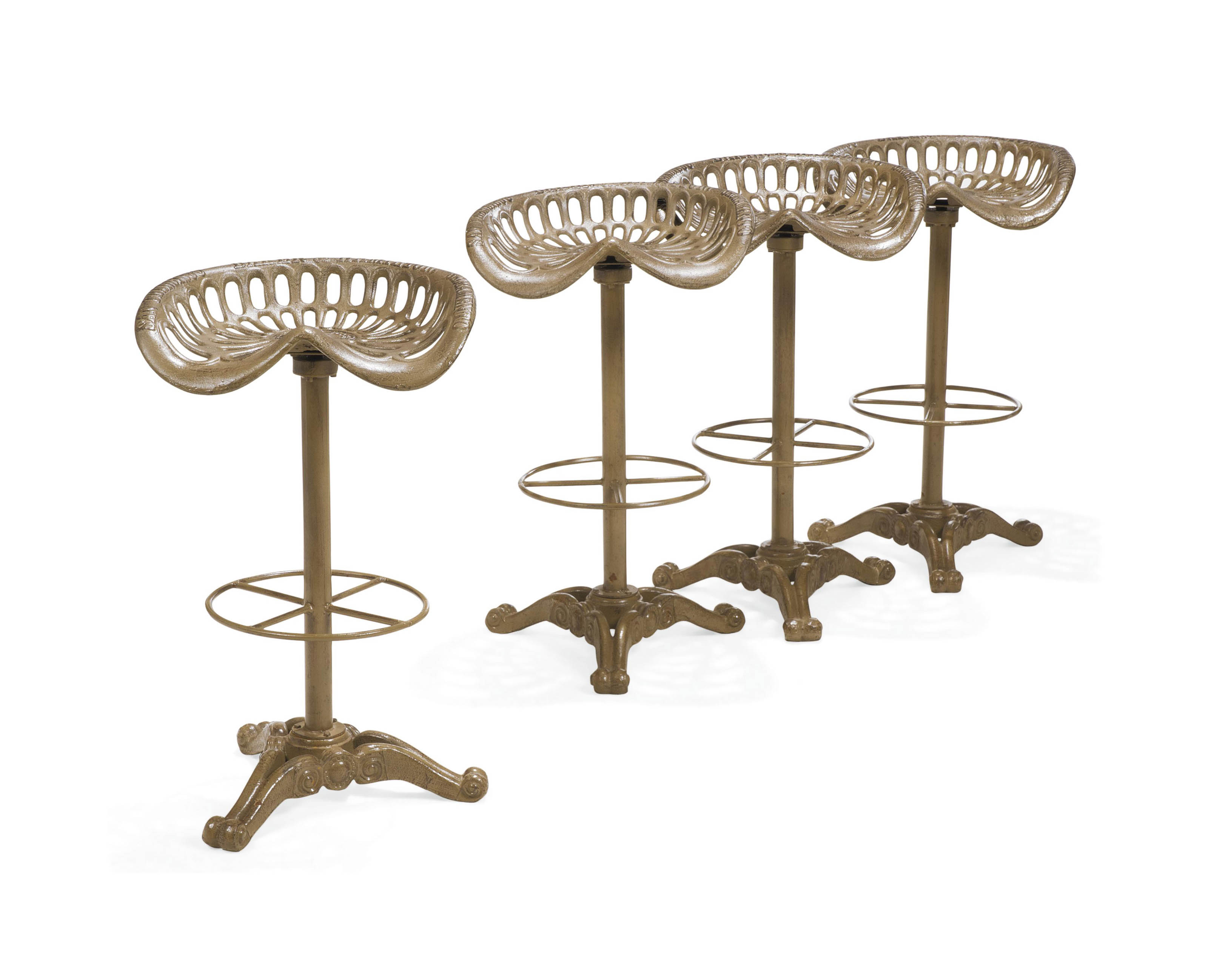 FOUR NOVELTY CAST-IRON BAR STOOLS ADAPTED FROM TRACTOR SEATS , 20TH FOUR NOVELTY CAST-IRON BAR STOOLS ADAPTED FROM TRACTOR SEATS , 20TH