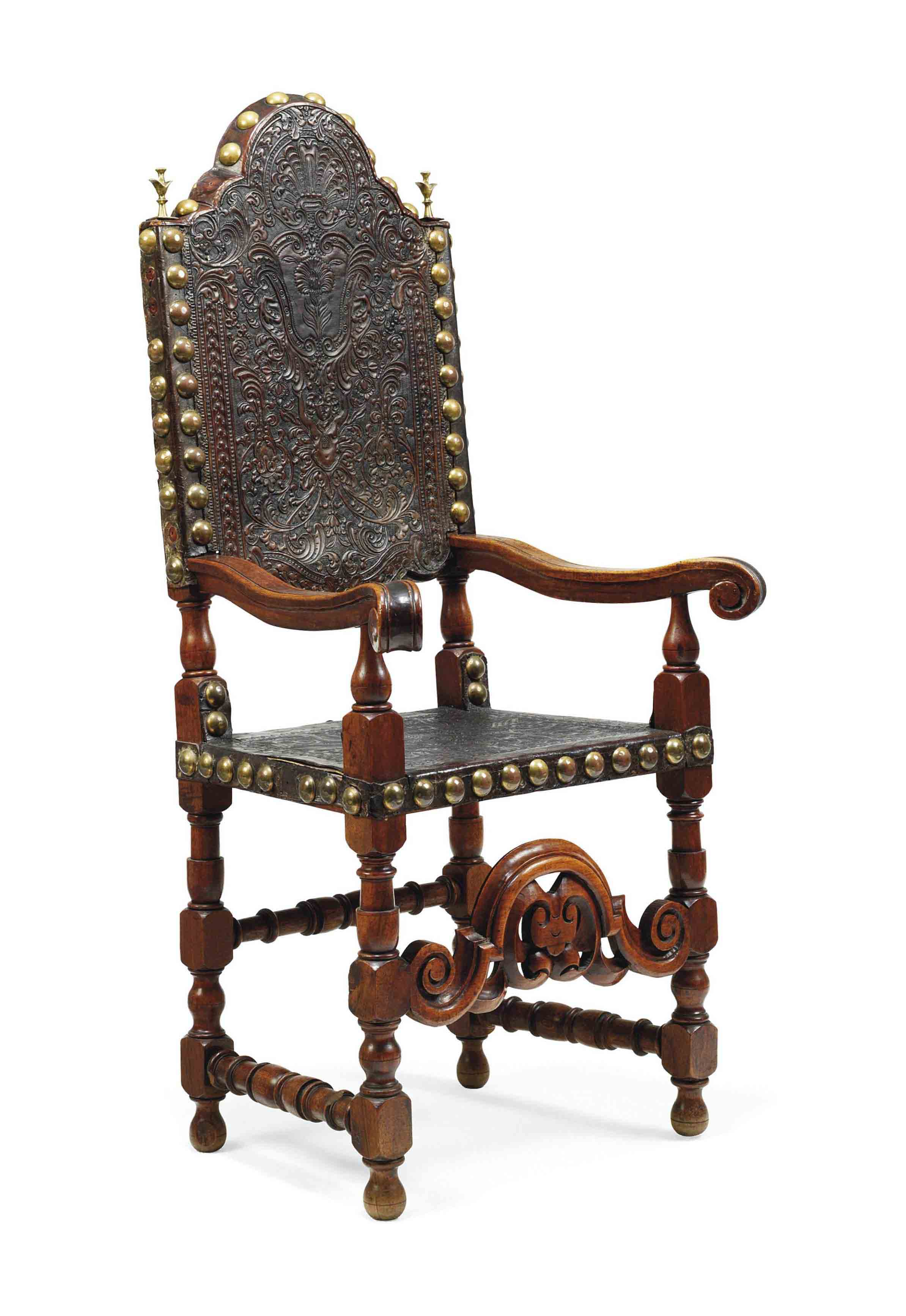 A SPANISH WALNUT AND EMBOSSED LEATHER ARMCHAIR