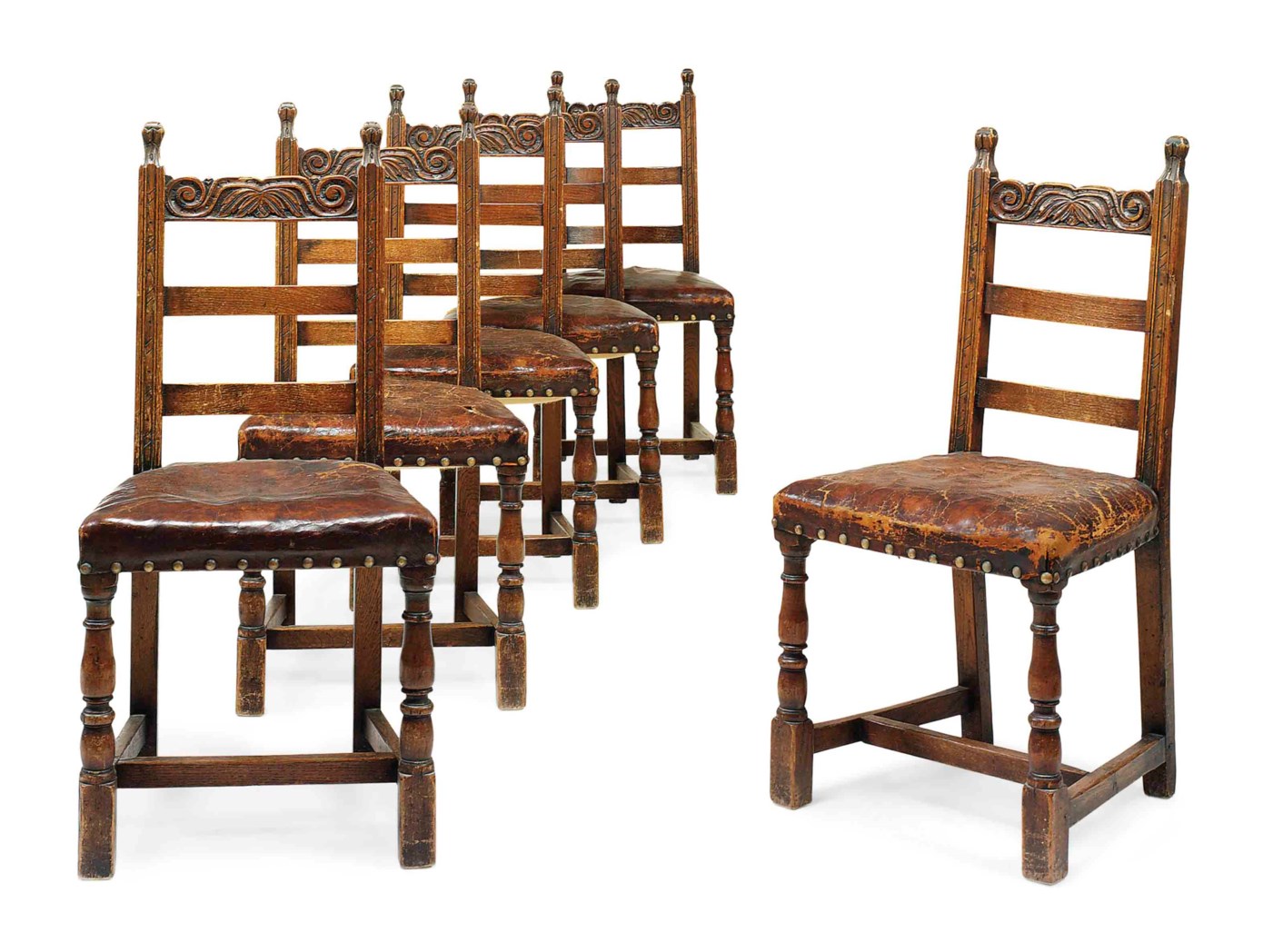 A SET OF SIX SPANISH CARVED OAK DININGCHAIRS