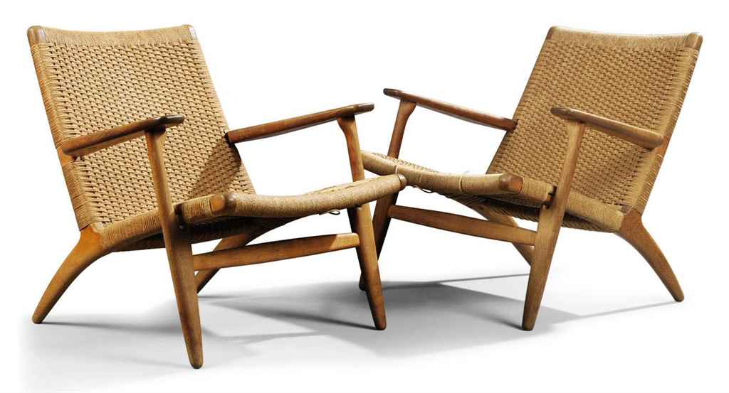 A Pair Of Hans Wegner Oak And Rush Seated Lounge Chairs Made By Carl Hansen