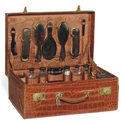 A CROCODILE TRAVELLING VANITY CASE , ARMY & NAVY STORES ...