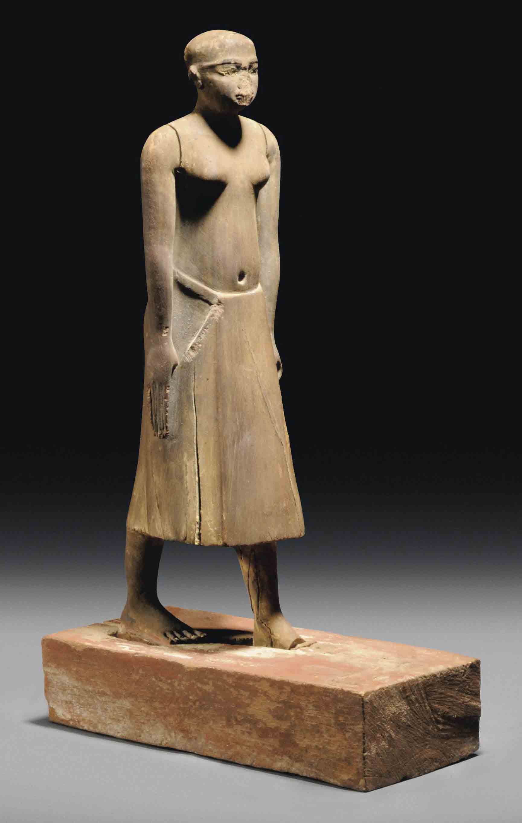 AN EGYPTIAN GESSOPAINTED WOOD STATUE OF THE NOBLEMAN, KHETY , EARLY