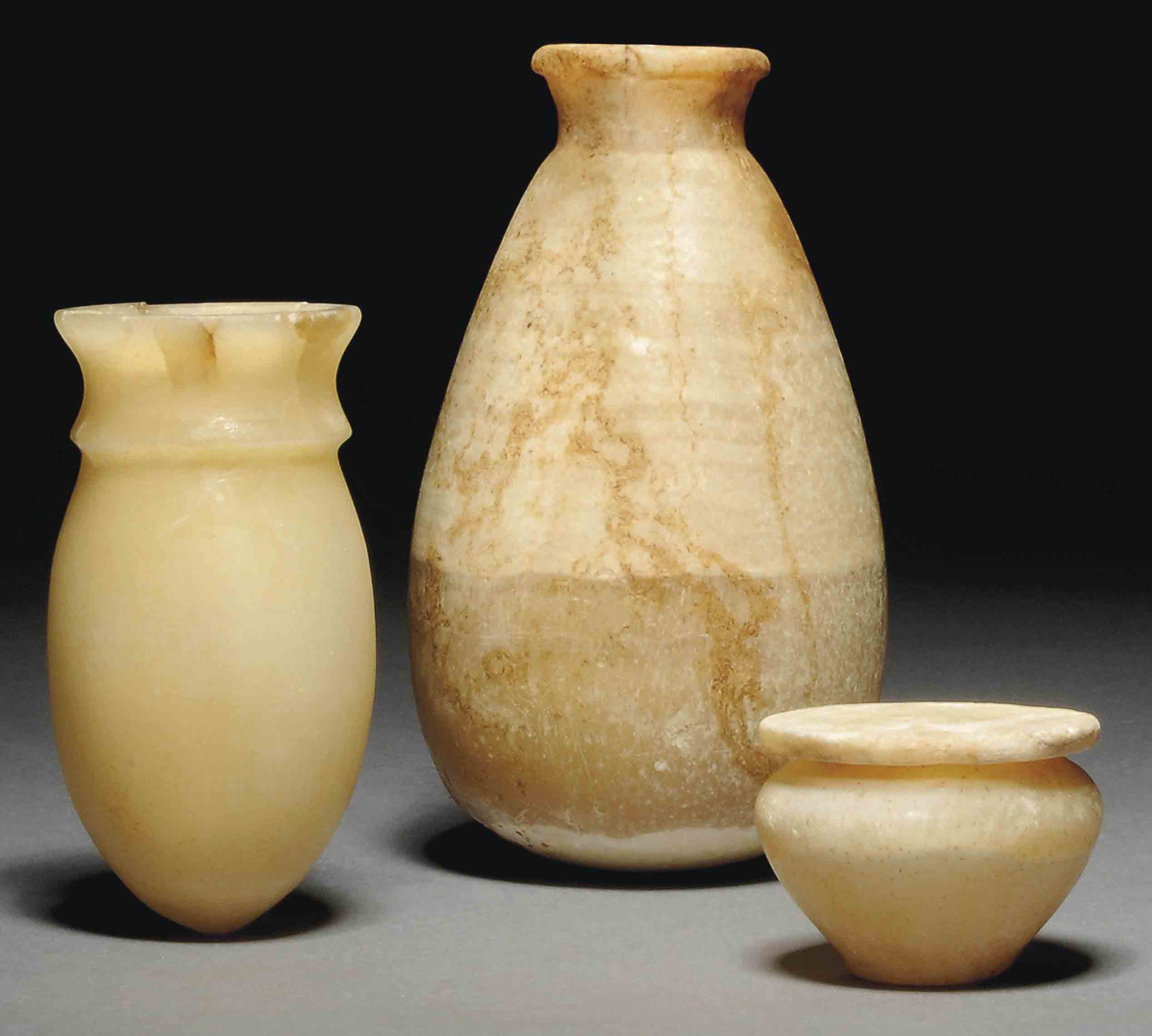 AN EGYPTIAN ALABASTER COSMETIC JAR AND LID , MIDDLE KINGDOM, CIRCA 1985