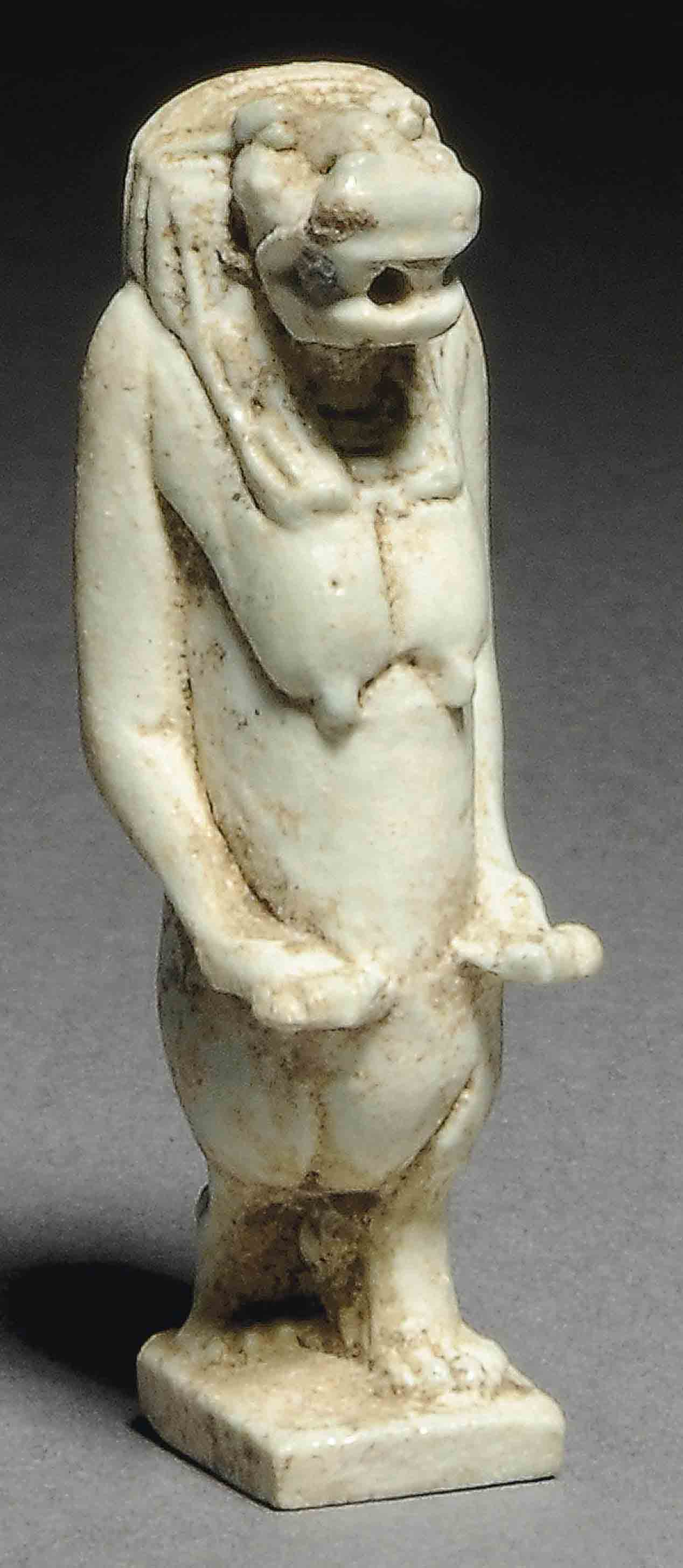 AN EGYPTIAN PALE GREEN GLAZED COMPOSITION FIGURINE OF THOERIS