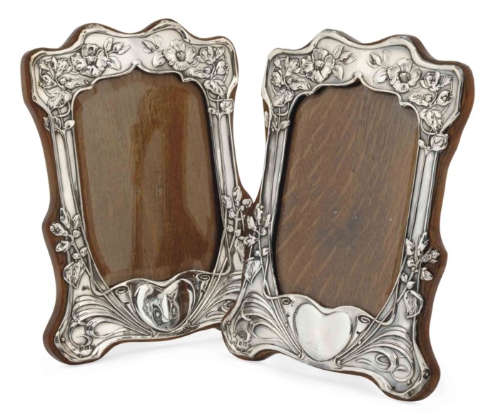 A PAIR OF EDWARDIAN ART NOUVEAU SILVER PHOTOGRAPH FRAMES