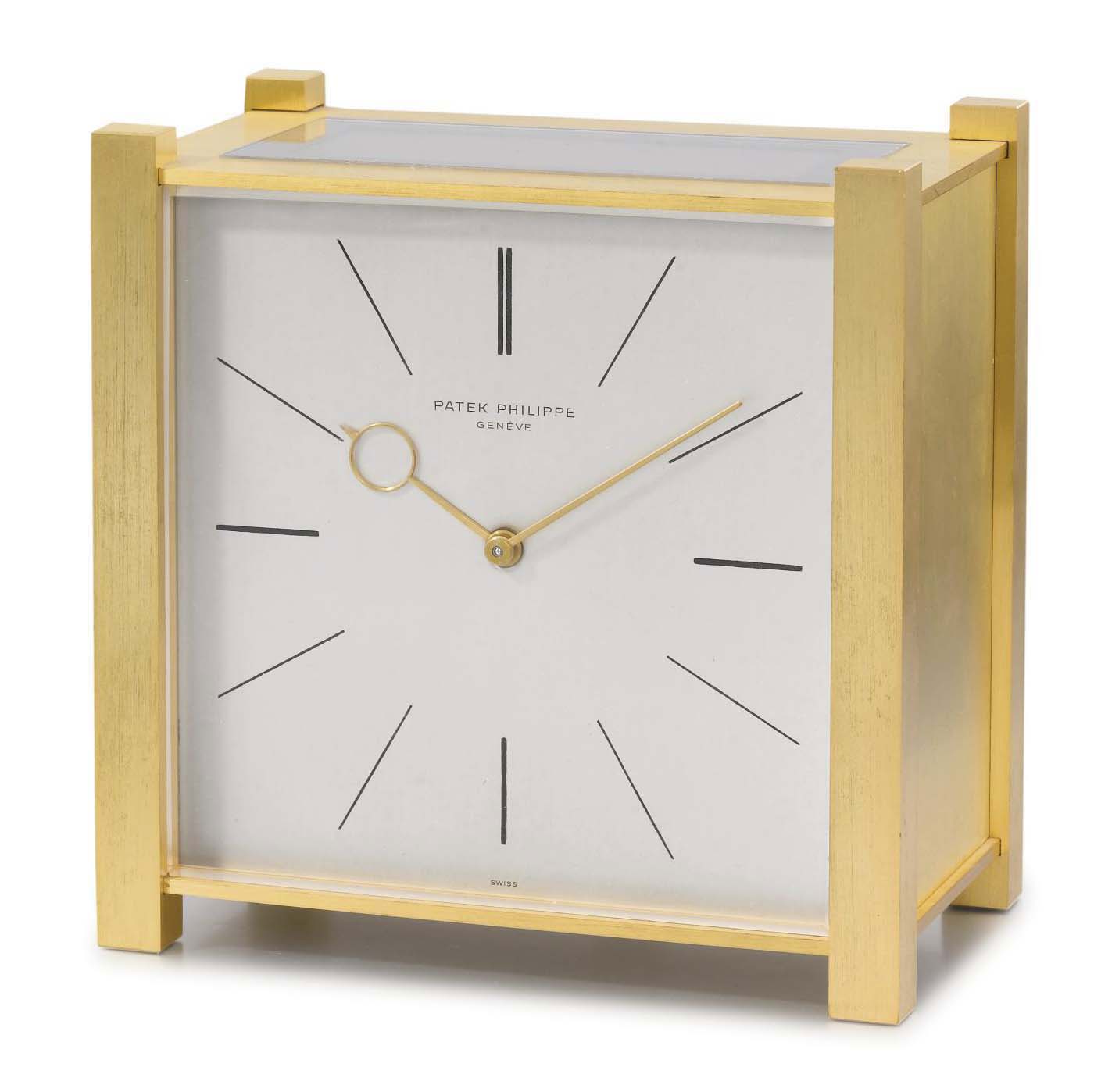 Patek Philippe. A gilt brass square solarpowered desk clock with