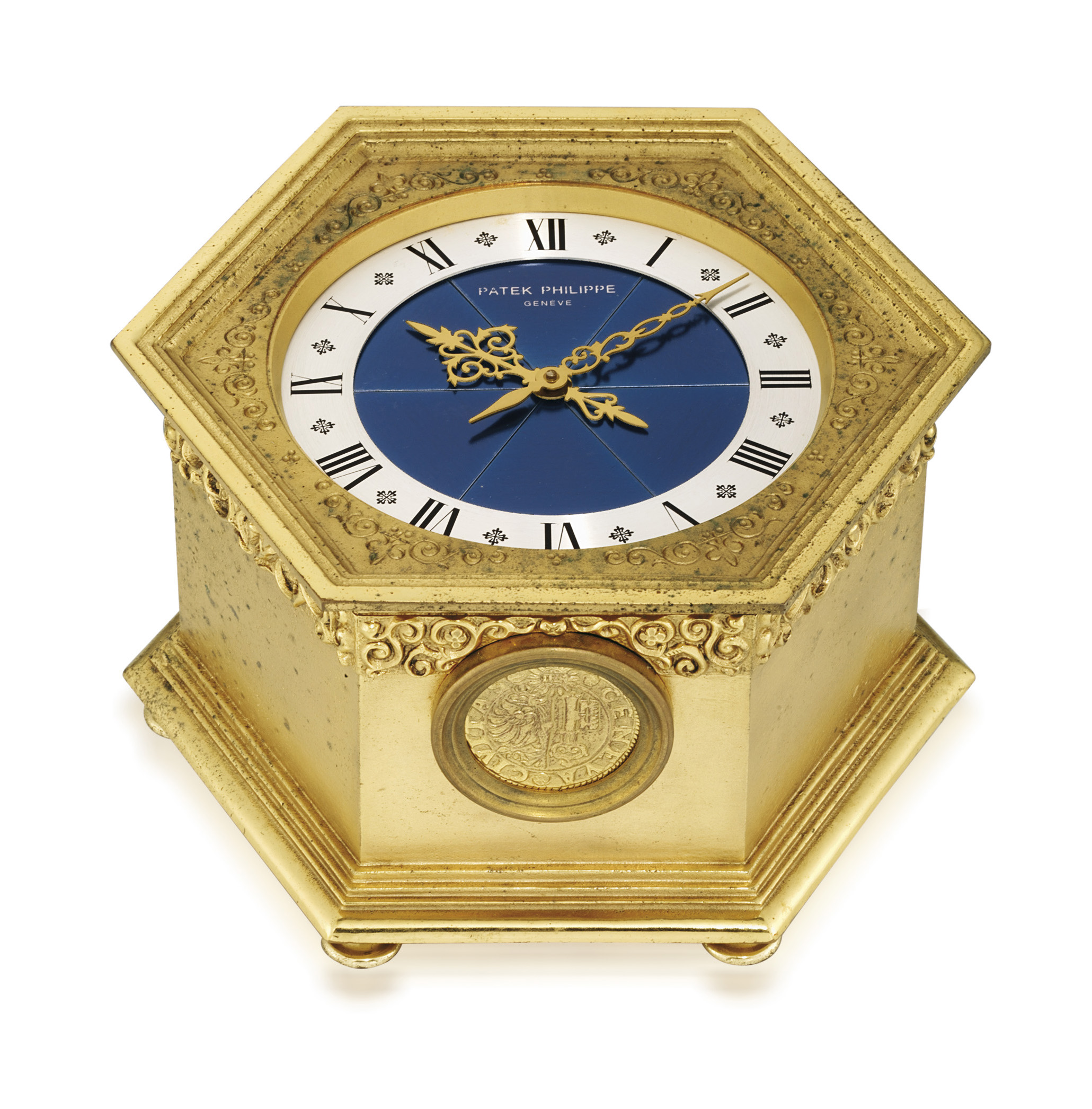 PATEK PHILIPPE. A GILT BRASS HEXAGONAL SOLAR POWERED QUARTZ TABLE CLOCK