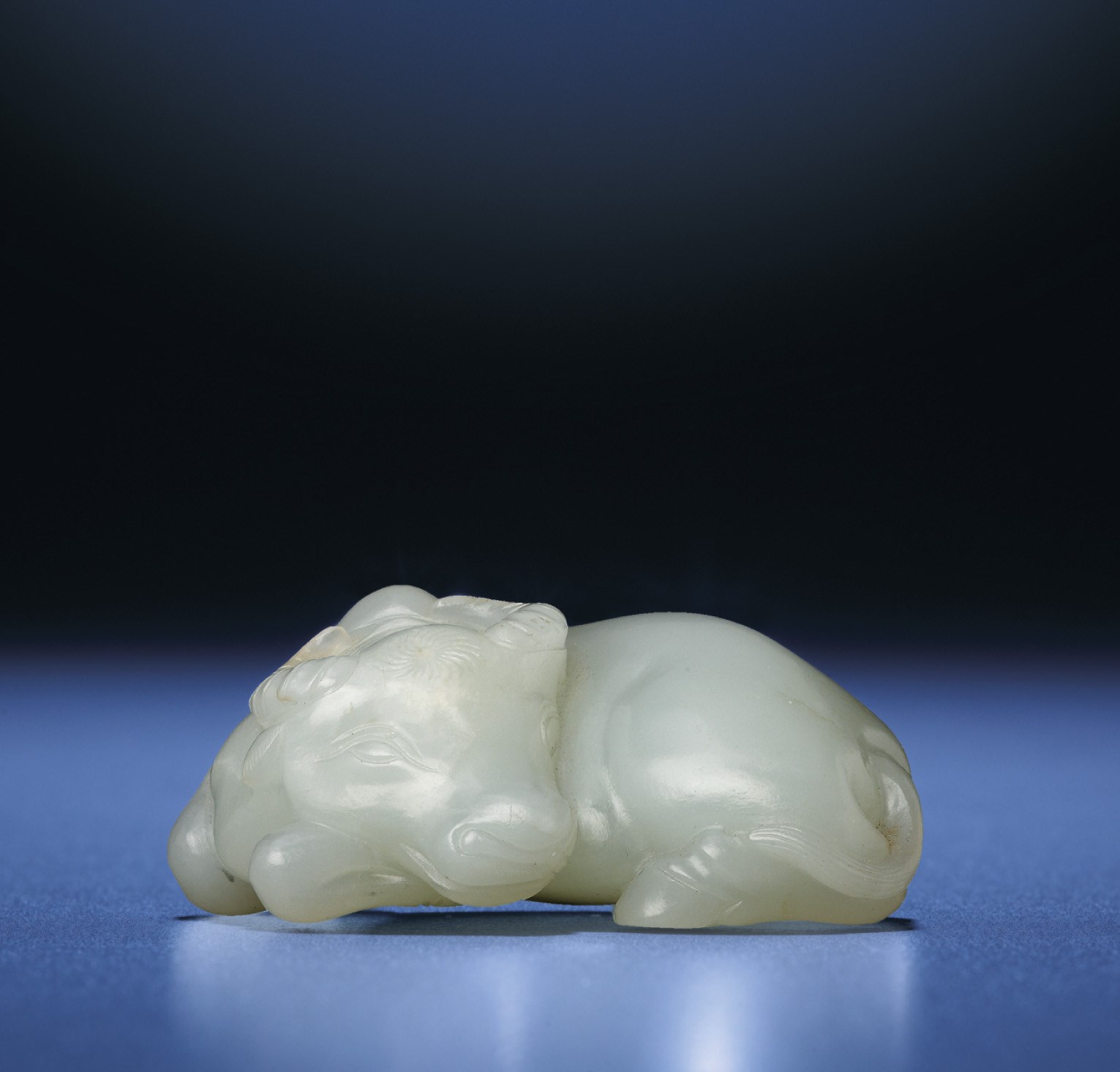 A FINE WHITE JADE CARVING OF AN OX