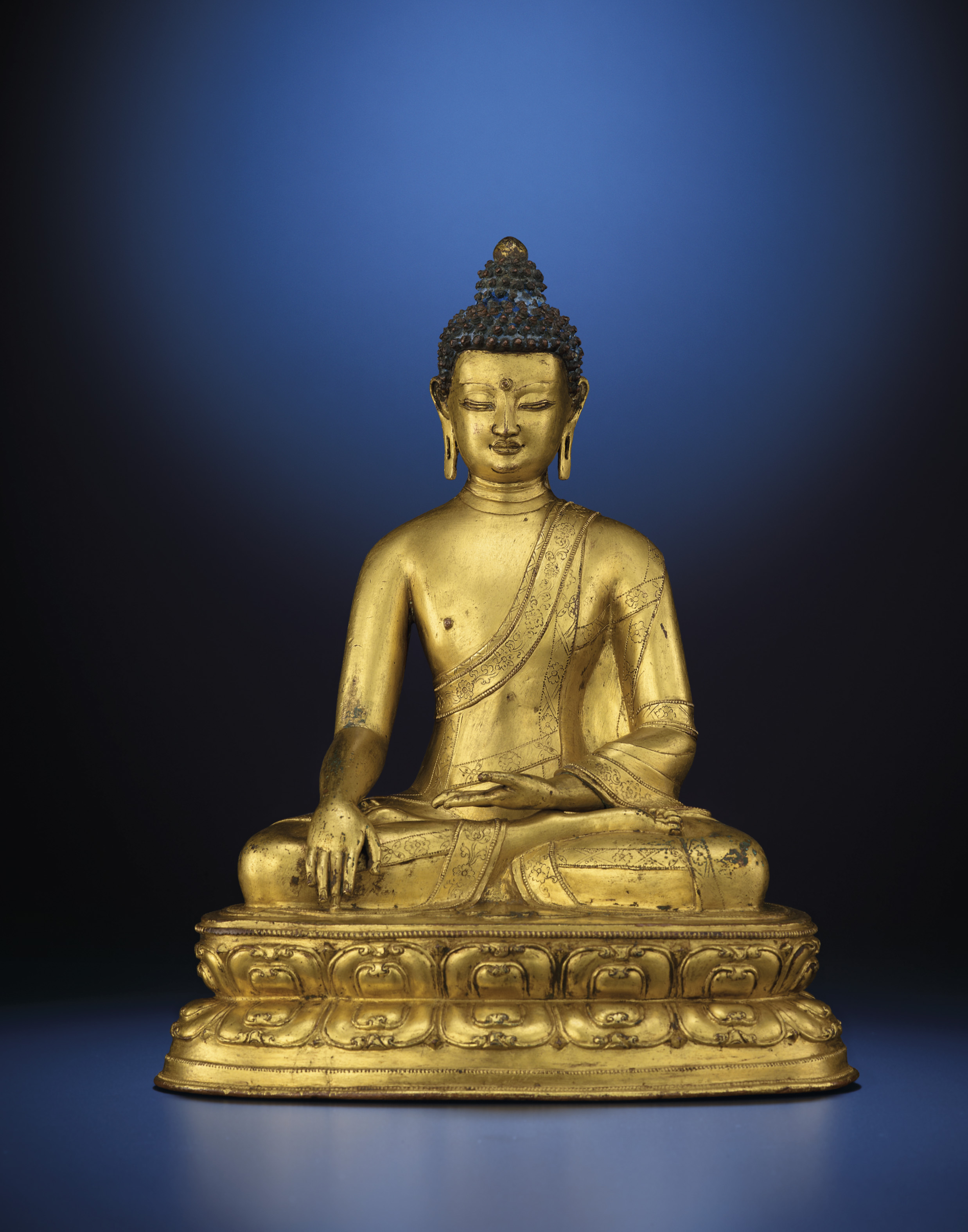 A TIBETAN GILTBRONZE SEATED FIGURE OF BUDDHA SAKYAMUNI , 15TH CENTURY