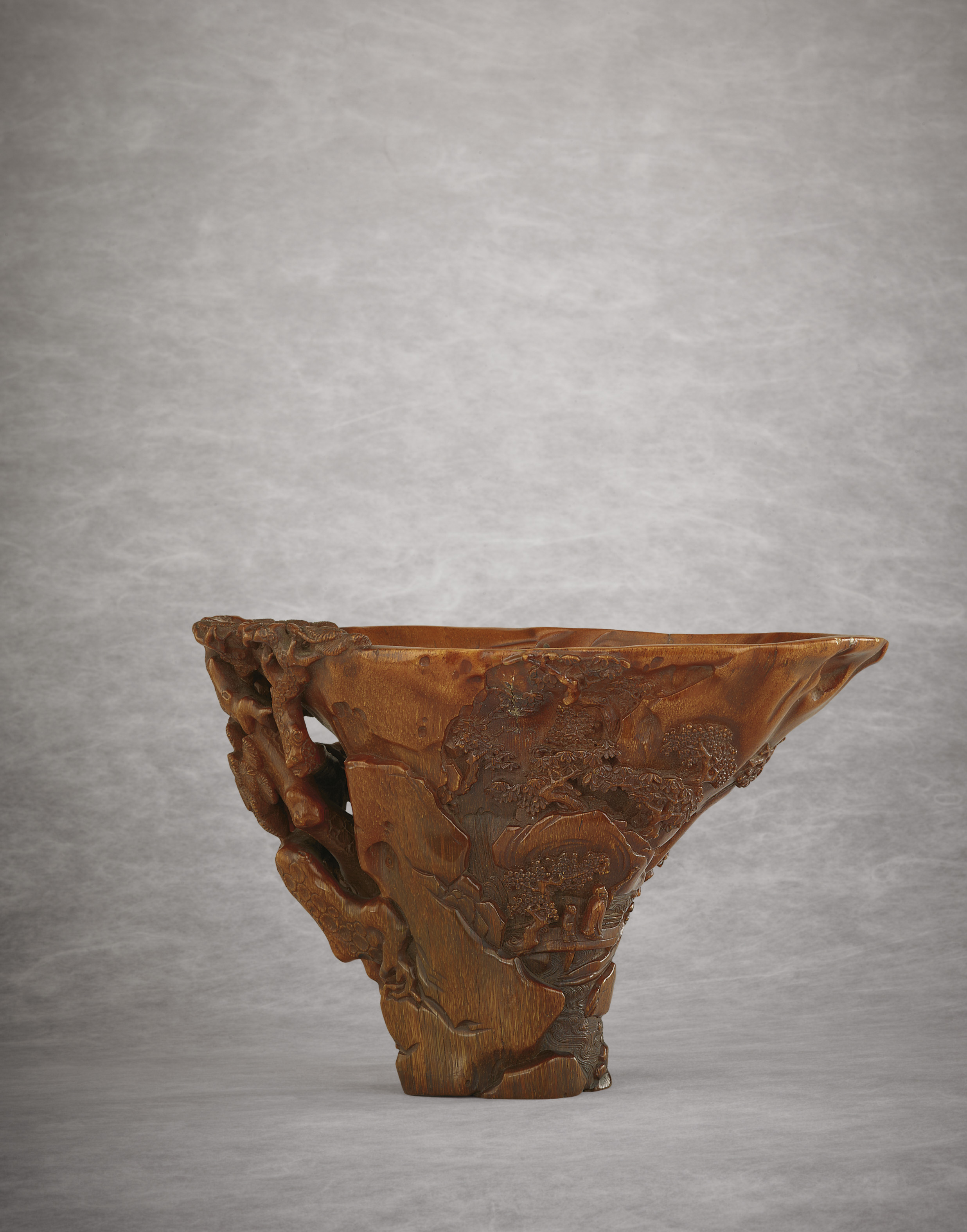 AN EXCEPTIONALLY WELL-CARVED RHINOCEROS HORN LIBATION CUP AN EXCEPTIONALLY WELL-CARVED RHINOCEROS HORN LIBATION CUP