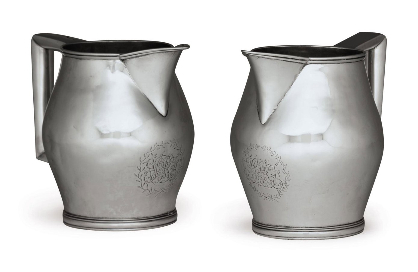 A PAIR OF SILVER PITCHERS