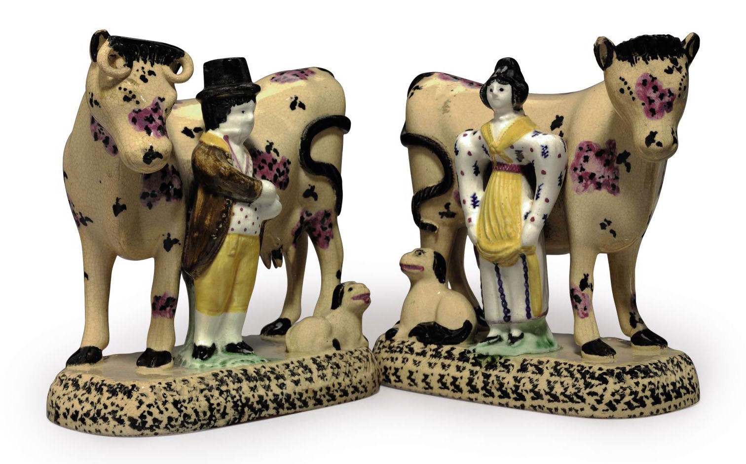 A PAIR OF YORKSHIRE POTTERY MILKING GROUPS