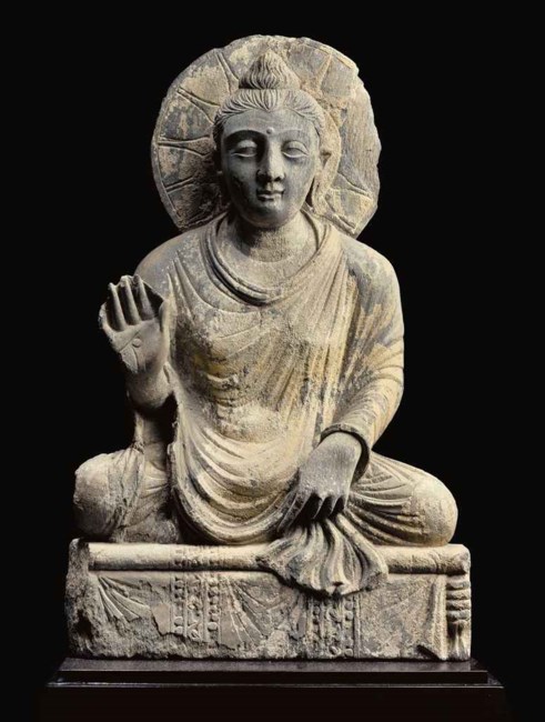 A gray schist figure of the seated Buddha , GANDHARA, 2ND/3RD CENTURY ...