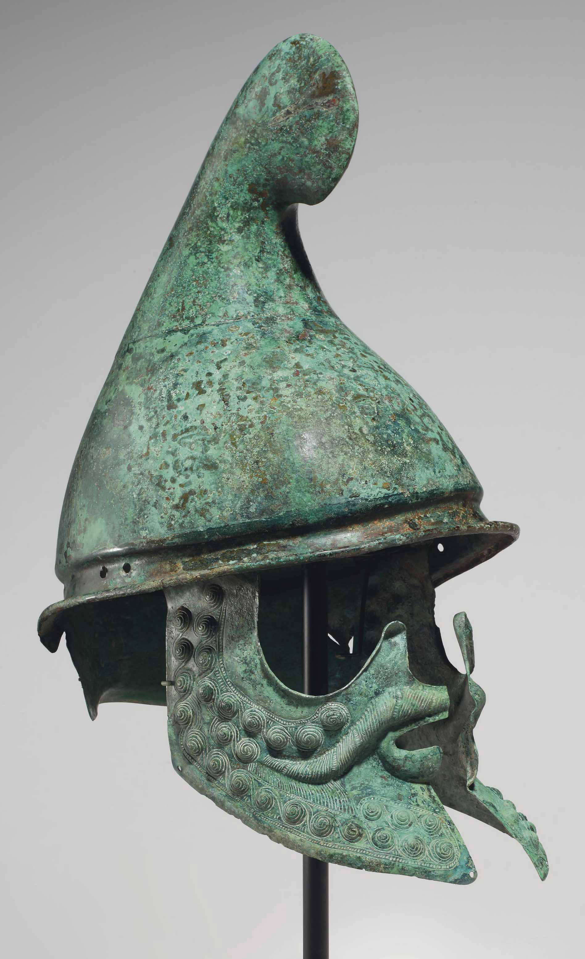 A GREEK BRONZE HELMET OF PHRYGIAN TYPE , LATE CLASSICAL TO EARLY