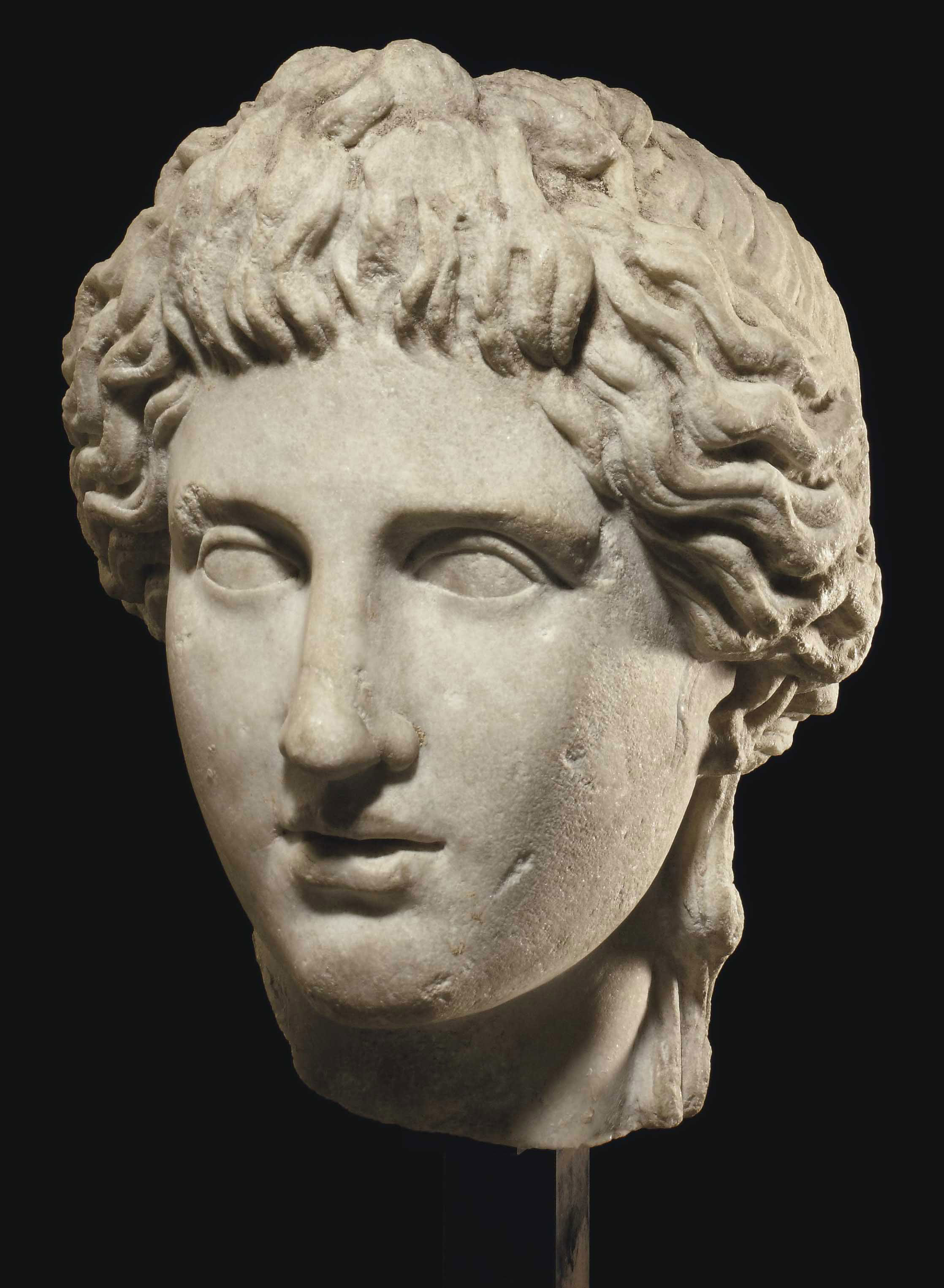 A ROMAN MARBLE HEAD OF APOLLO , CIRCA 1ST2ND CENTURY A.D. Christie's