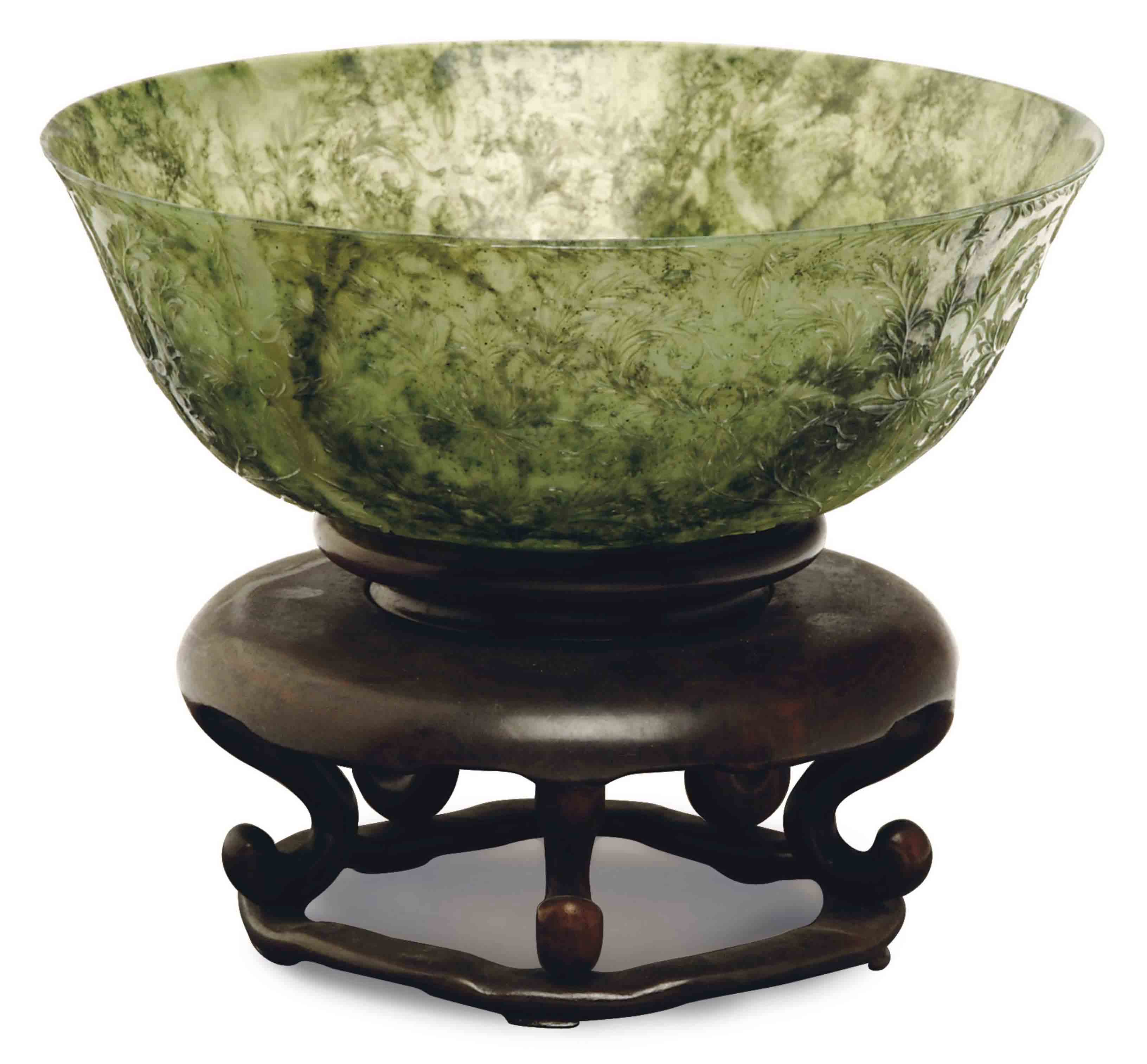 A CHINESE CARVED GREEN JADE BOWL, Christie's