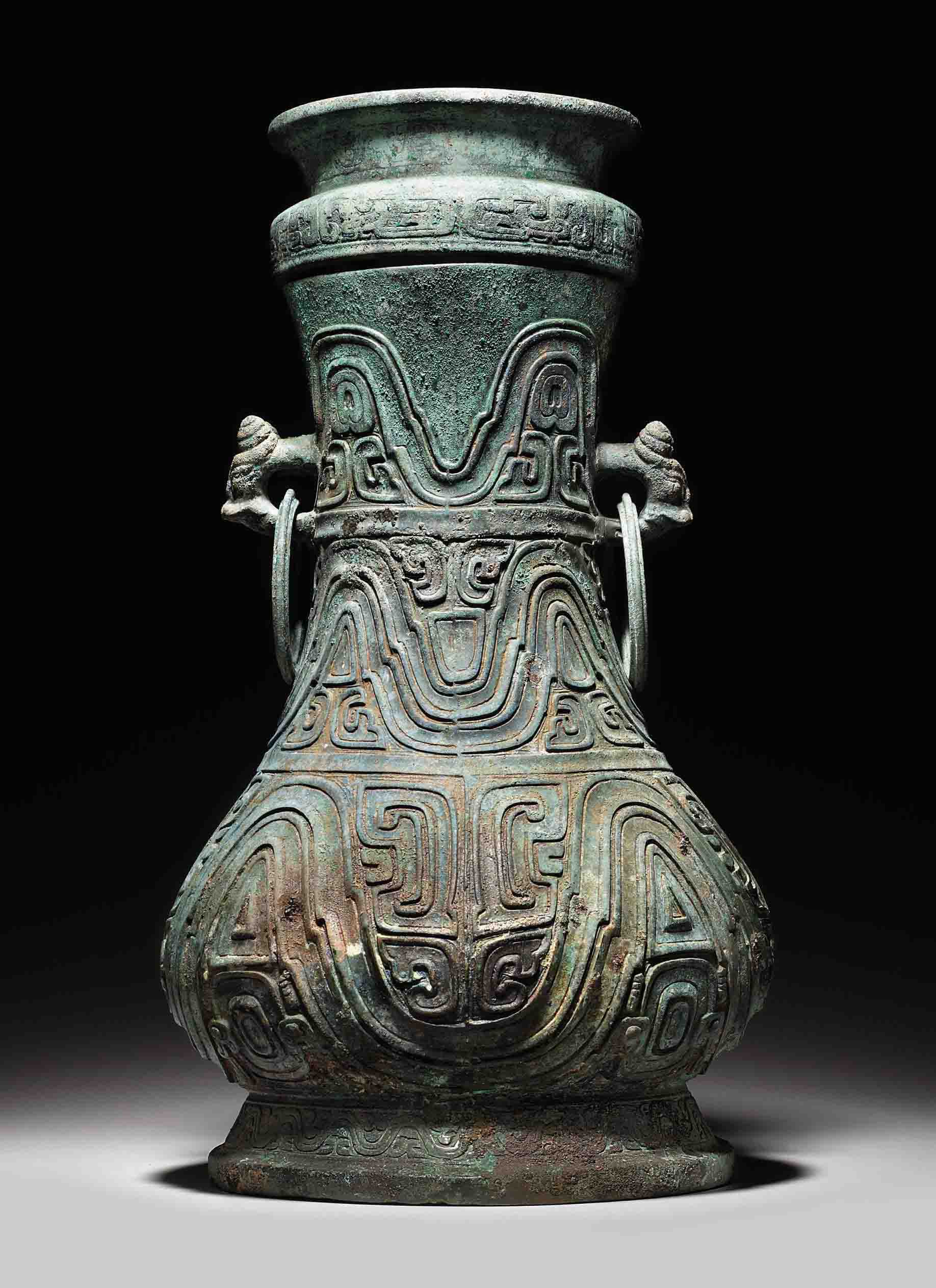 A RARE LARGE RITUAL BRONZE WINE VESSEL AND A COVER, HU , MIDDLE WESTERN ZHOU DYNASTY, CIRCA 9TH