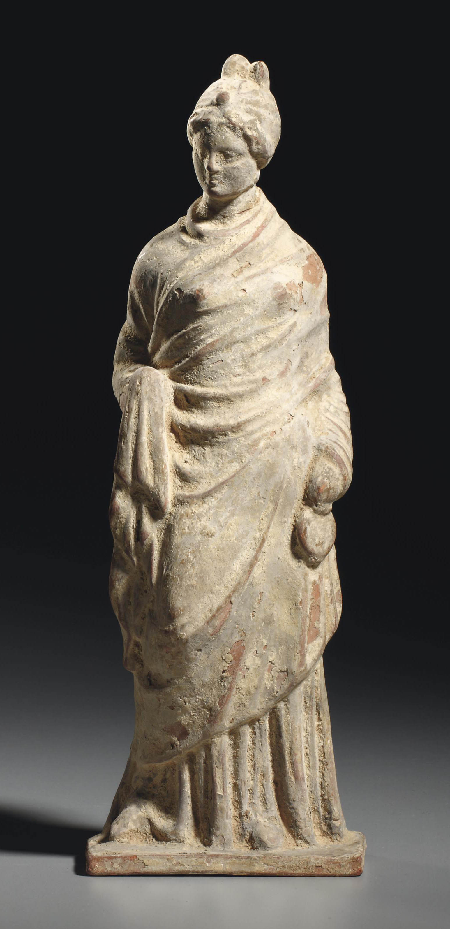 A GREEK TERRACOTTA FEMALE FIGURE , HELLENISTIC PERIOD, CIRCA 3RD