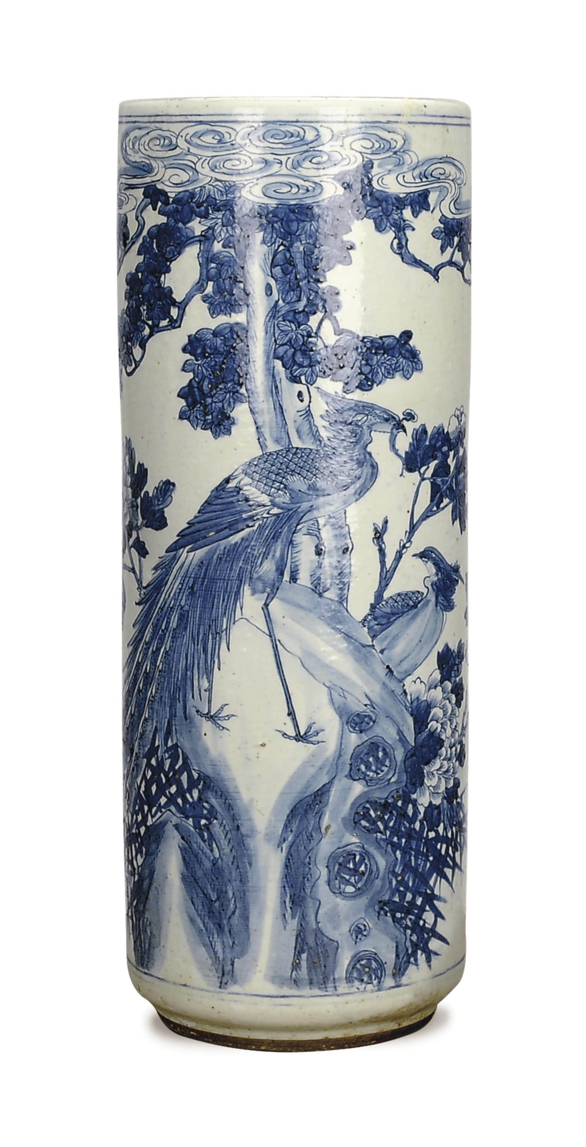 A CHINESE BLUE AND WHITE UMBRELLA STAND DECORATED WITH PHOENIX AMONGST