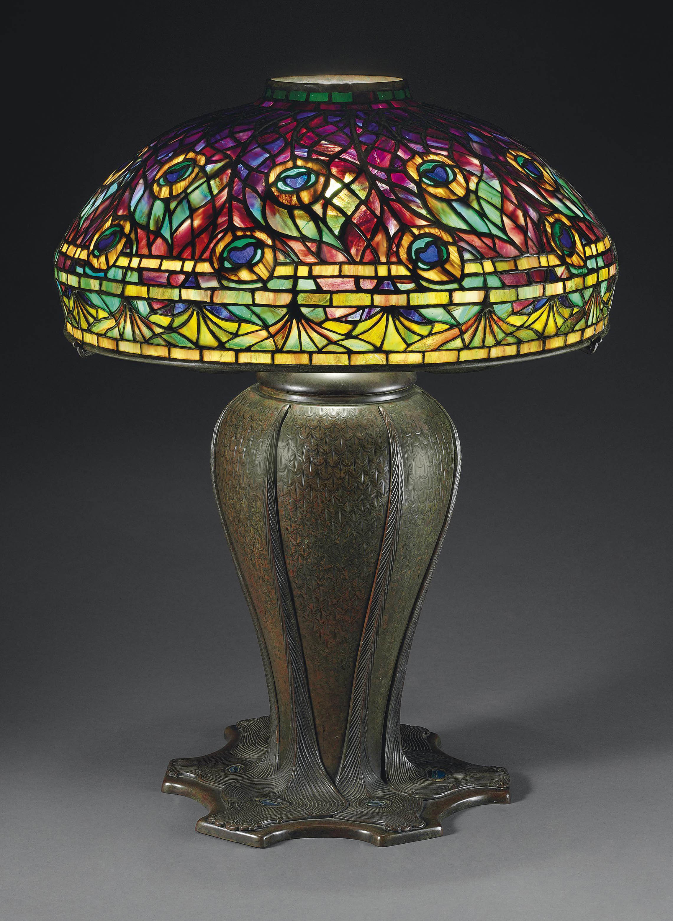 TIFFANY STUDIOS A PEACOCK LEADED GLASS AND BRONZE TABLE LAMP